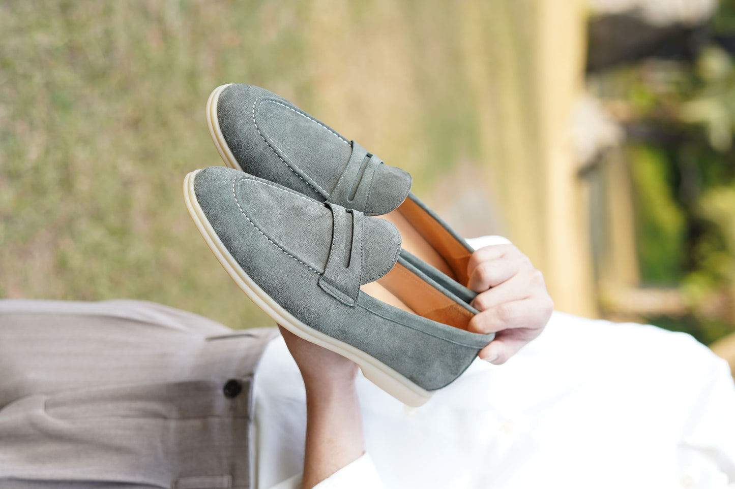 Men’s pale cyan mist suede leather penny loafers with classic strap detail and lightweight cream sole.