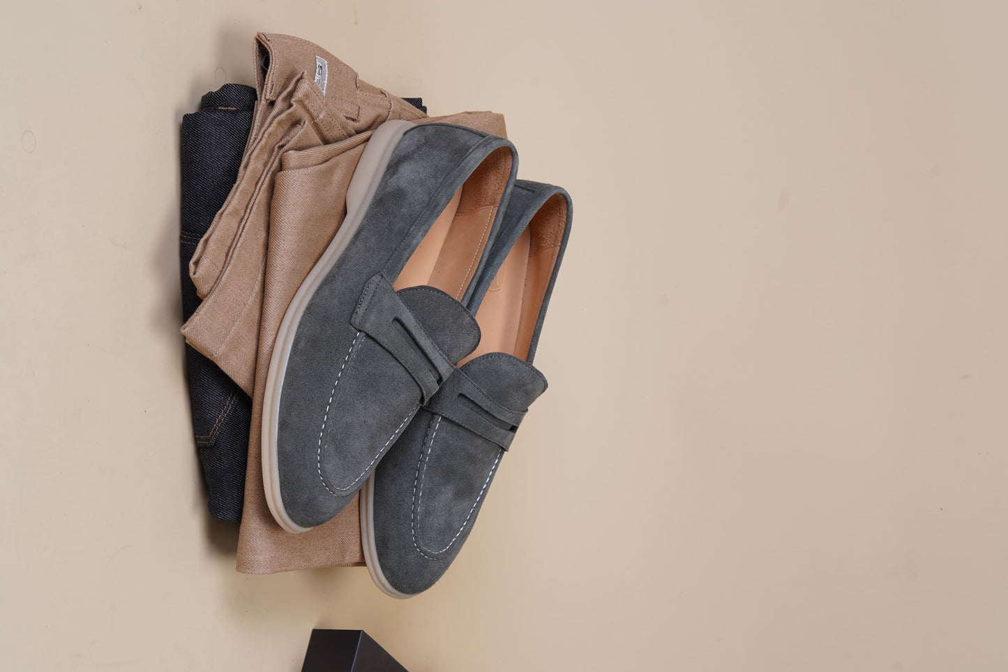 Men’s pale cyan mist suede leather penny loafers with classic strap detail and lightweight cream sole.