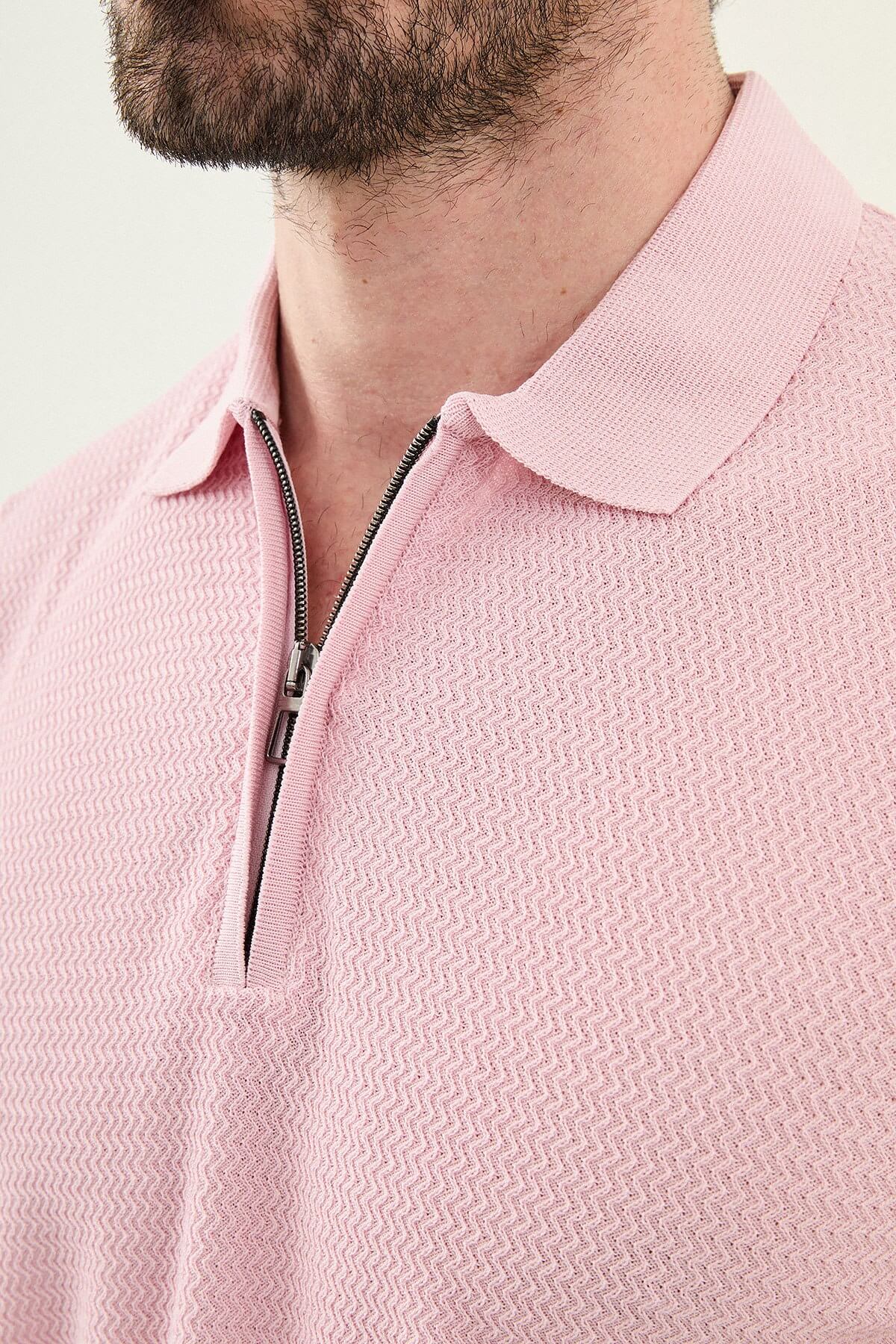 Man wearing a pink slim-fit quarter-zip polo T-shirt, short sleeves, standing against a neutral background, styled for summer casual wear.