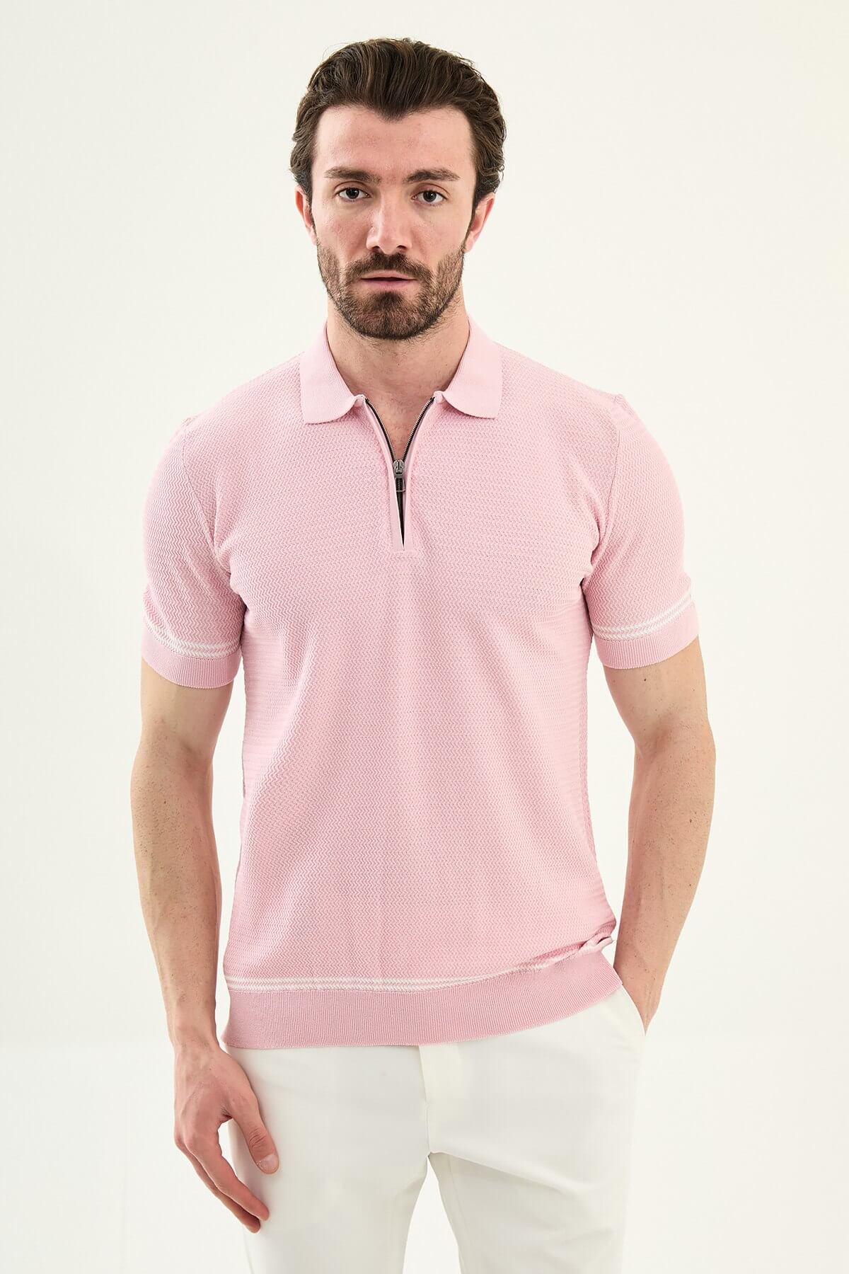 Man wearing a pink slim-fit quarter-zip polo T-shirt, short sleeves, standing against a neutral background, styled for summer casual wear.