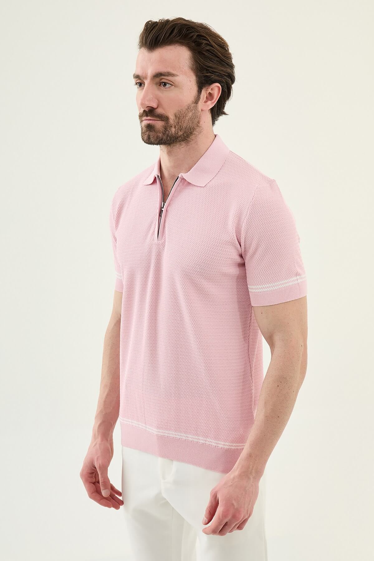 Man wearing a pink slim-fit quarter-zip polo T-shirt, short sleeves, standing against a neutral background, styled for summer casual wear.