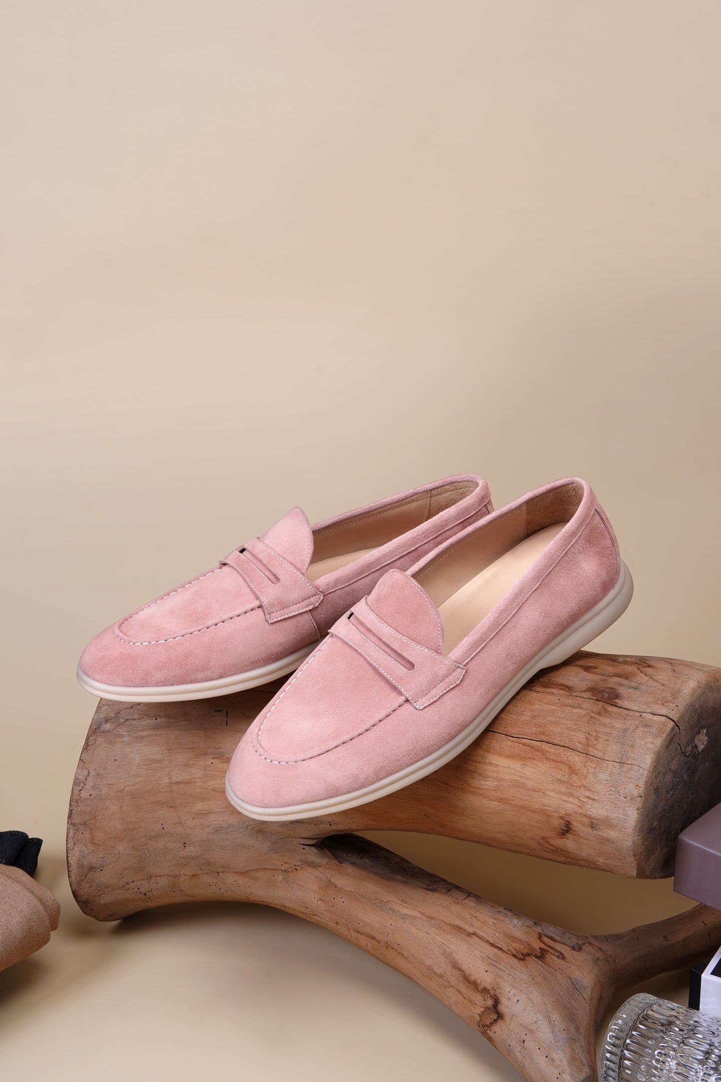 Men’s pink suede leather penny loafers with classic vamp strap detail and lightweight sole.