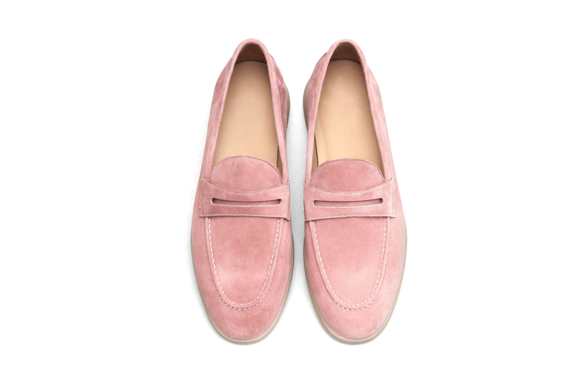 Men’s pink suede leather penny loafers with classic vamp strap detail and lightweight sole.