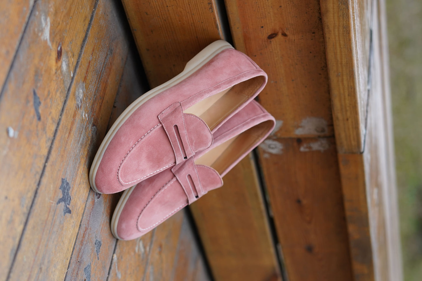 Men’s pink suede leather penny loafers with classic vamp strap detail and lightweight sole.