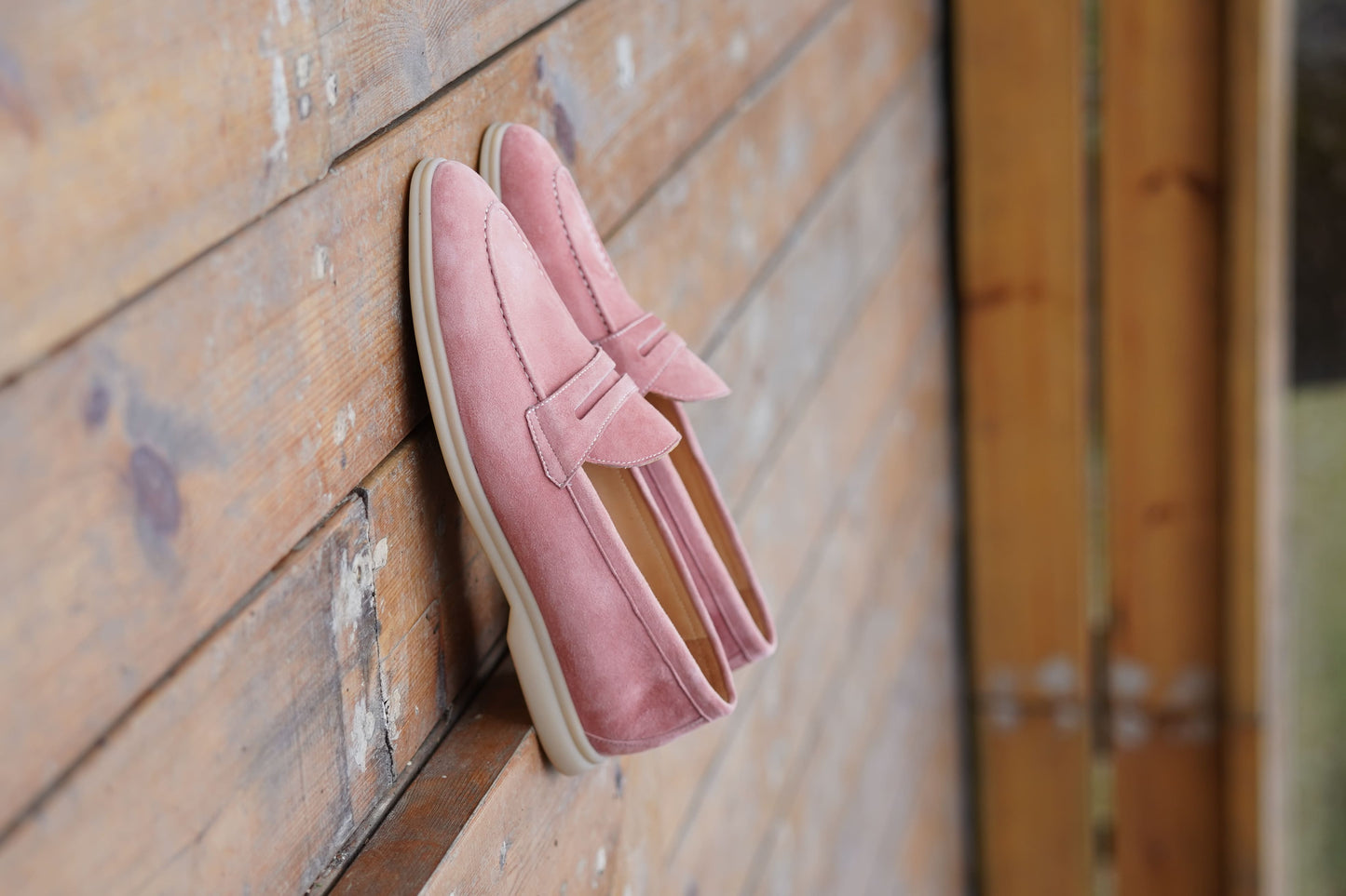 Men’s pink suede leather penny loafers with classic vamp strap detail and lightweight sole.