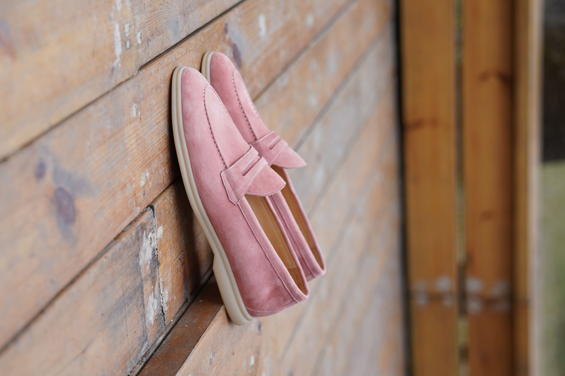 Men’s pink suede leather penny loafers with classic vamp strap detail and lightweight sole.