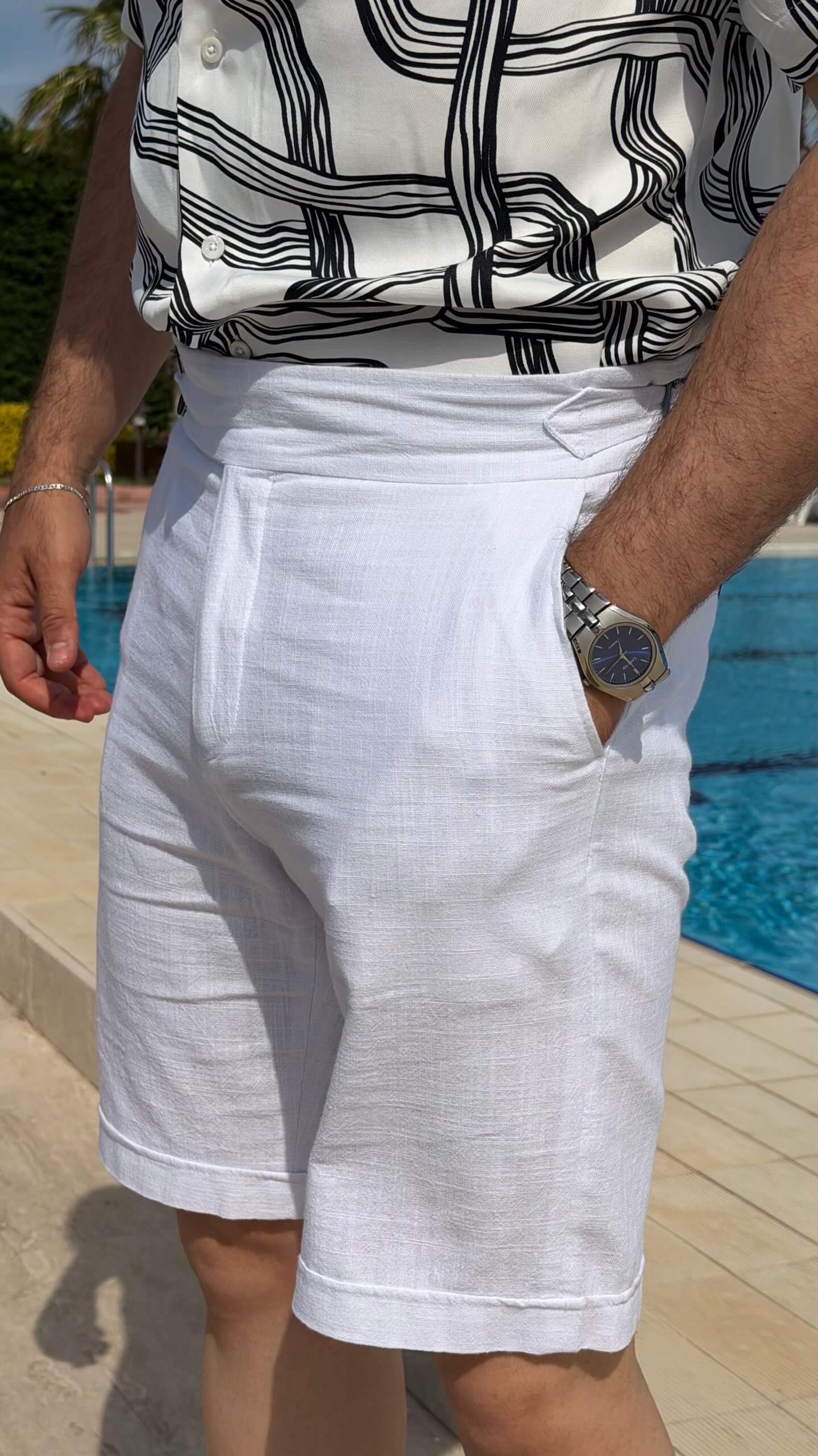 Men’s white linen shorts with tailored fit, button fastening, belt loops, and lightweight summer design.