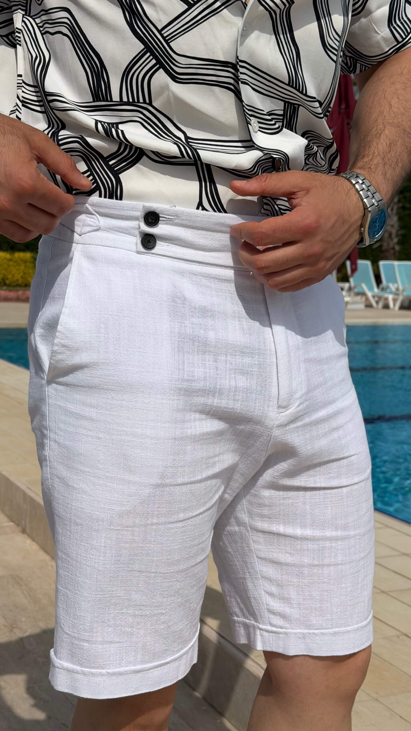 Men’s white linen shorts with tailored fit, button fastening, belt loops, and lightweight summer design.