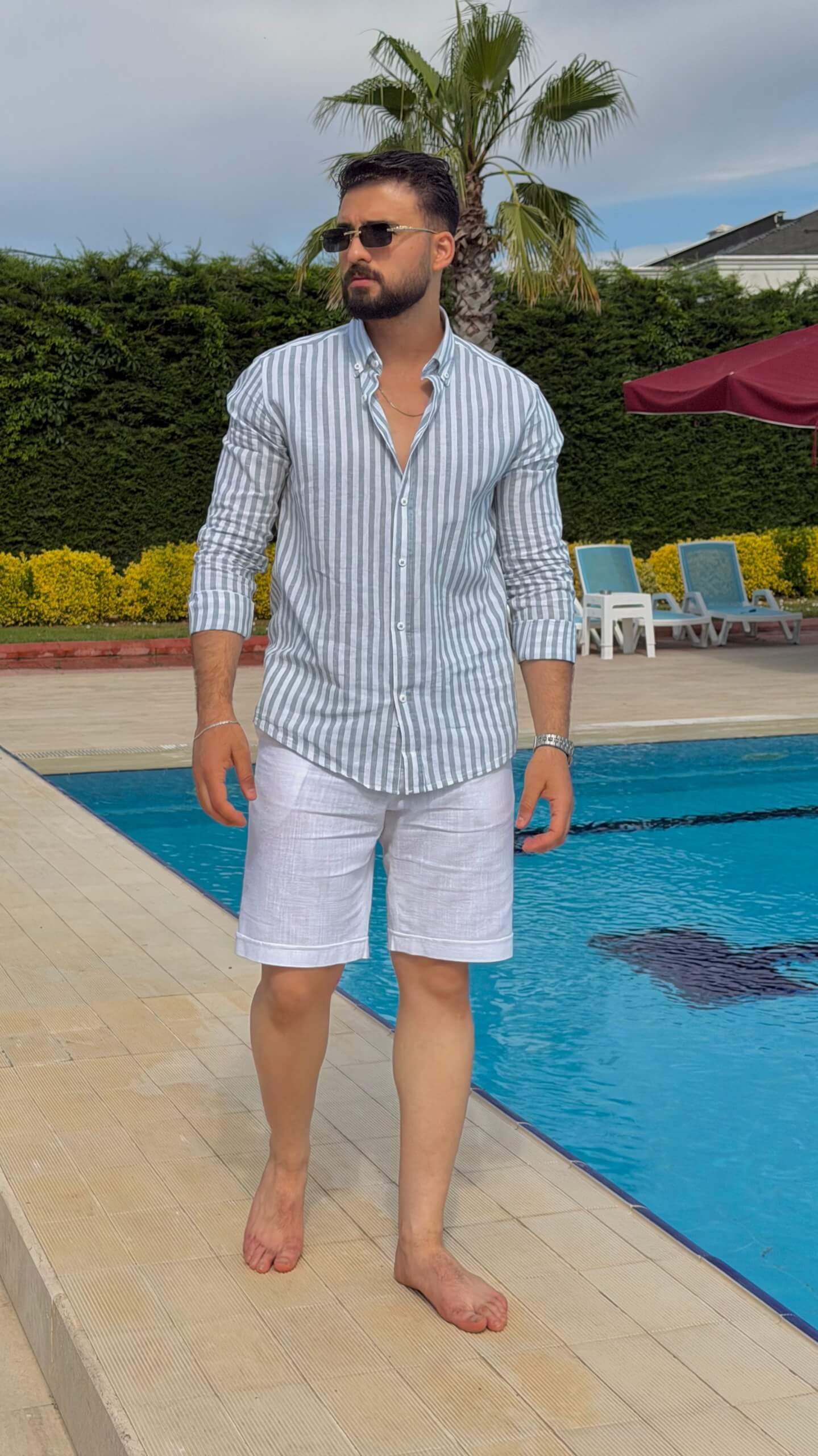 Men’s white linen shorts with tailored fit, button fastening, belt loops, and lightweight summer design.