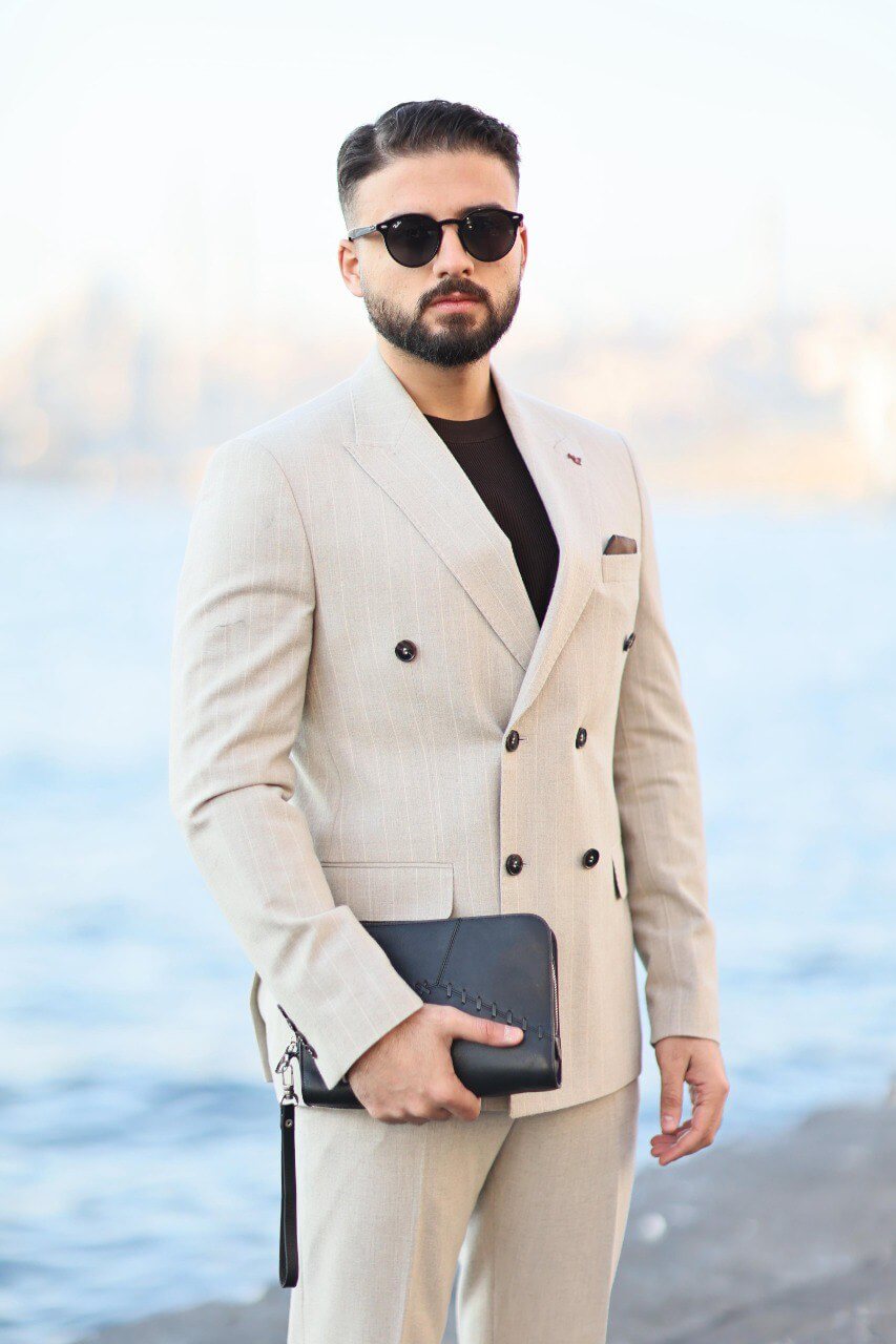 Men’s beige double-breasted pinstripe slim-fit suit styled with dark knit top
