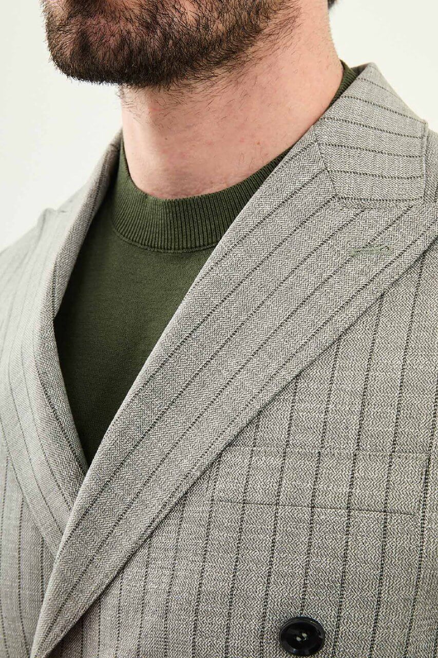 Men’s khaki slim fit double-breasted pinstripe suit jacket crafted from a cotton-viscose stretch blend for modern formal and smart occasion styling.