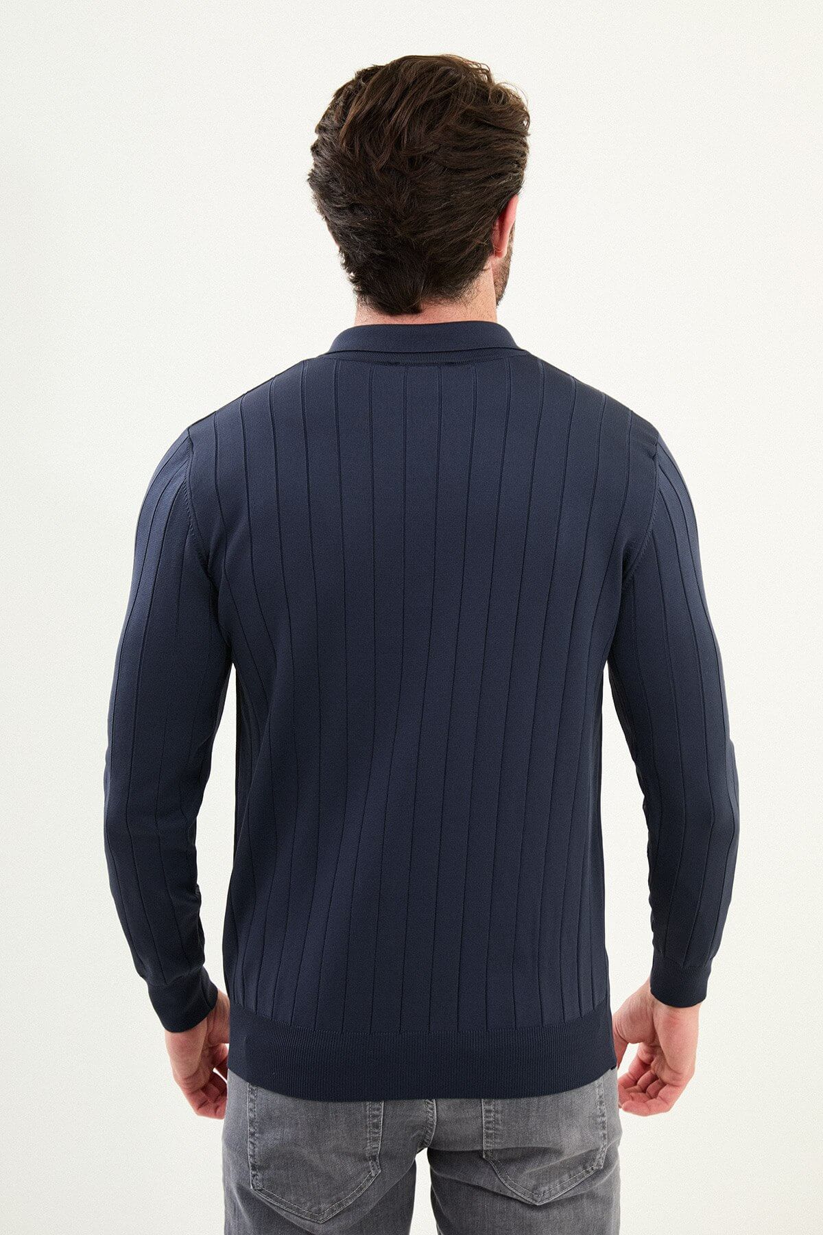 Men’s navy blue ribbed polo sweater with vertical knit pattern, slim fit smart casual knit styled with gray trousers