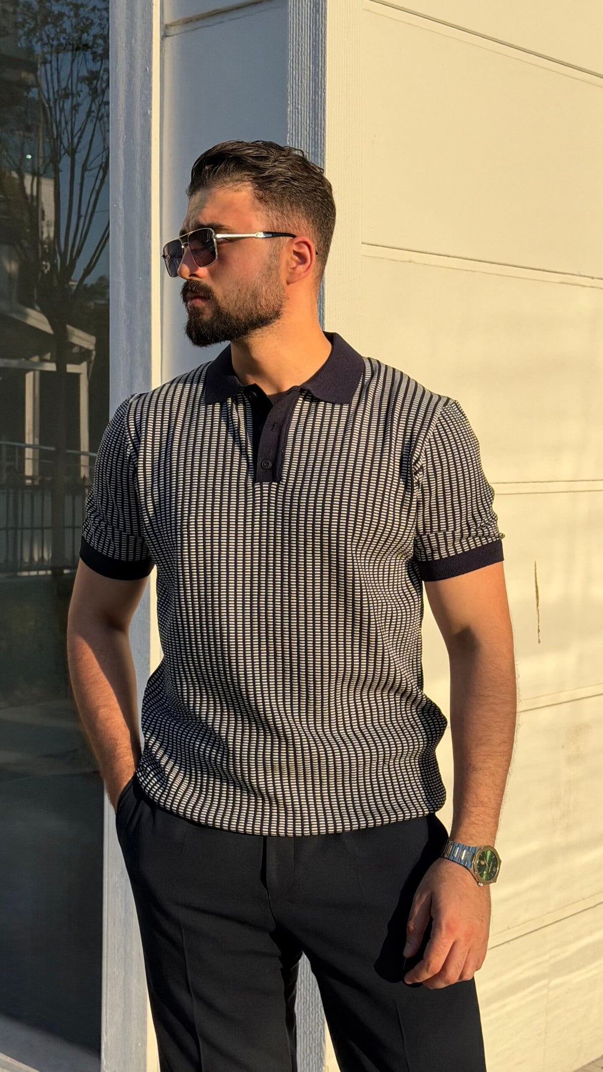 Men’s khaki textured short sleeve knit polo shirt with contrast collar styled with black trousers