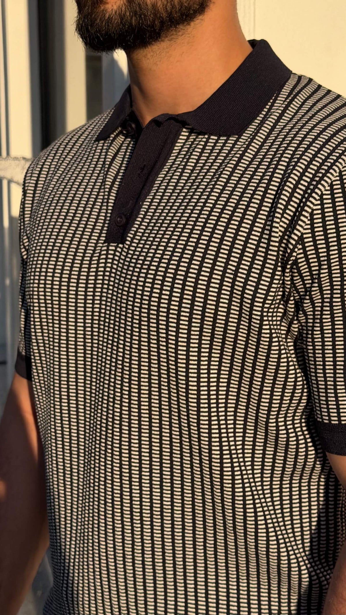 Men’s khaki textured short sleeve knit polo shirt with contrast collar styled with black trousers