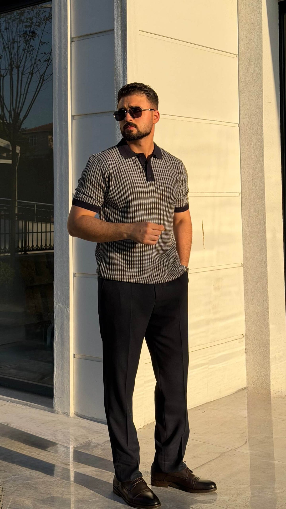 Men’s khaki textured short sleeve knit polo shirt with contrast collar styled with black trousers