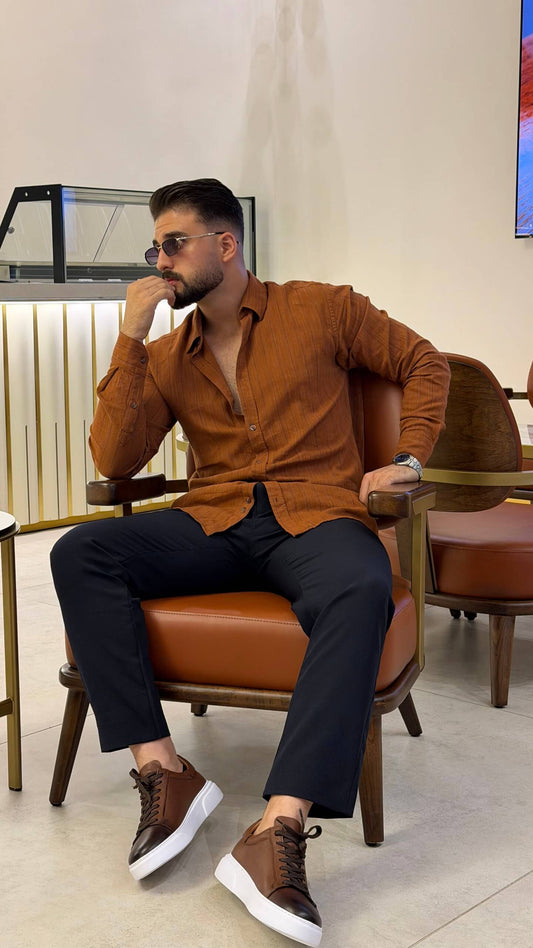 Men’s tile brown long sleeve cotton button-up shirt styled with black trousers and brown sneakers