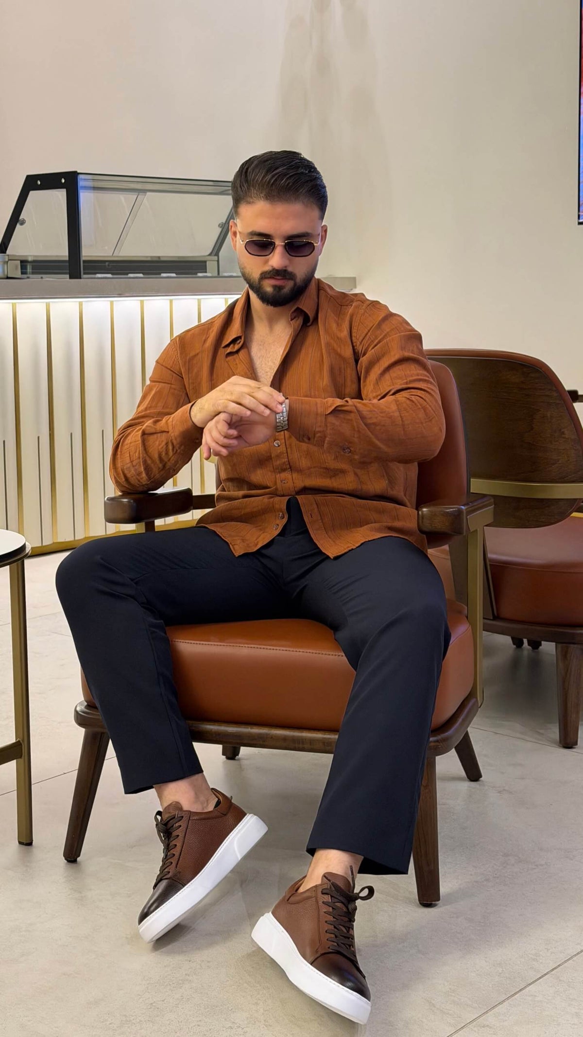 Men’s tile brown long sleeve cotton button-up shirt styled with black trousers and brown sneakers