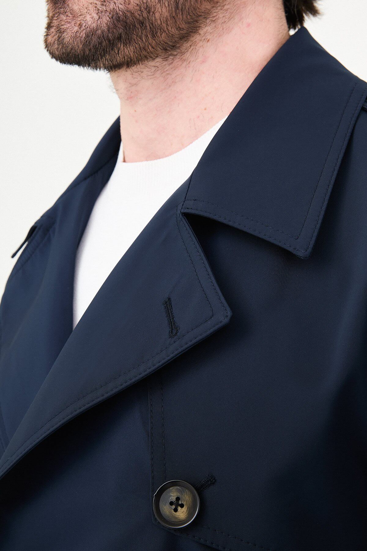 Men’s navy blue double breasted trench coat with belt and tailored fit for fall winter style