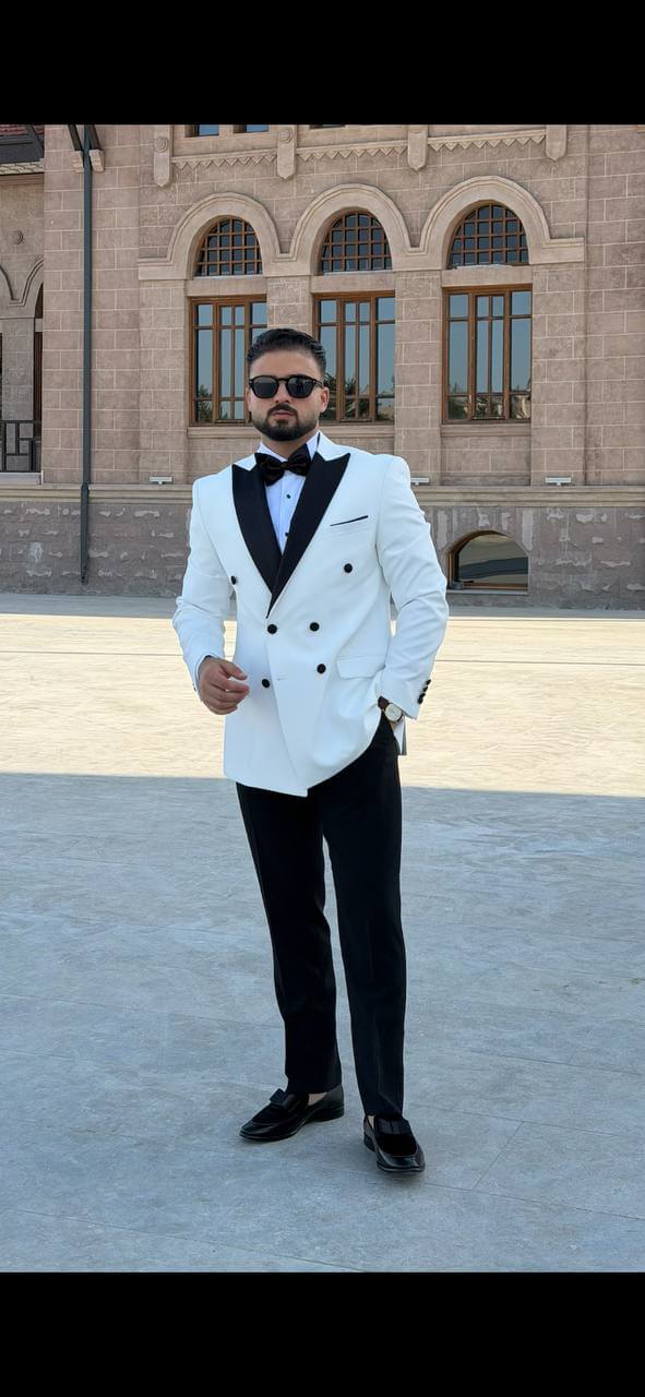 Men’s white double breasted tuxedo suit with black lapels for wedding and formal evening occasions