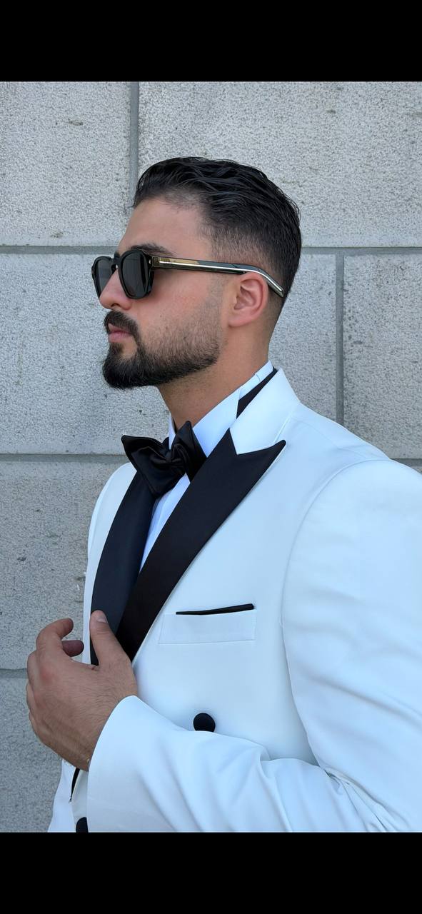 Men’s white double breasted tuxedo suit with black lapels for wedding and formal evening occasions