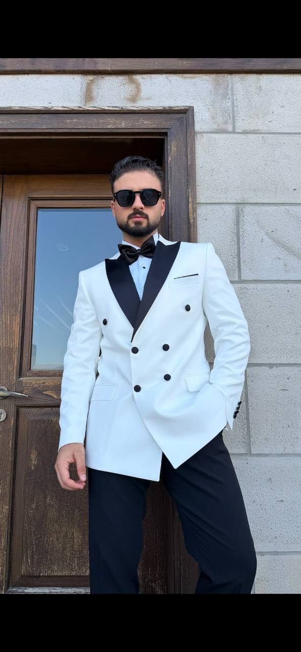 Men’s white double breasted tuxedo suit with black lapels for wedding and formal evening occasions