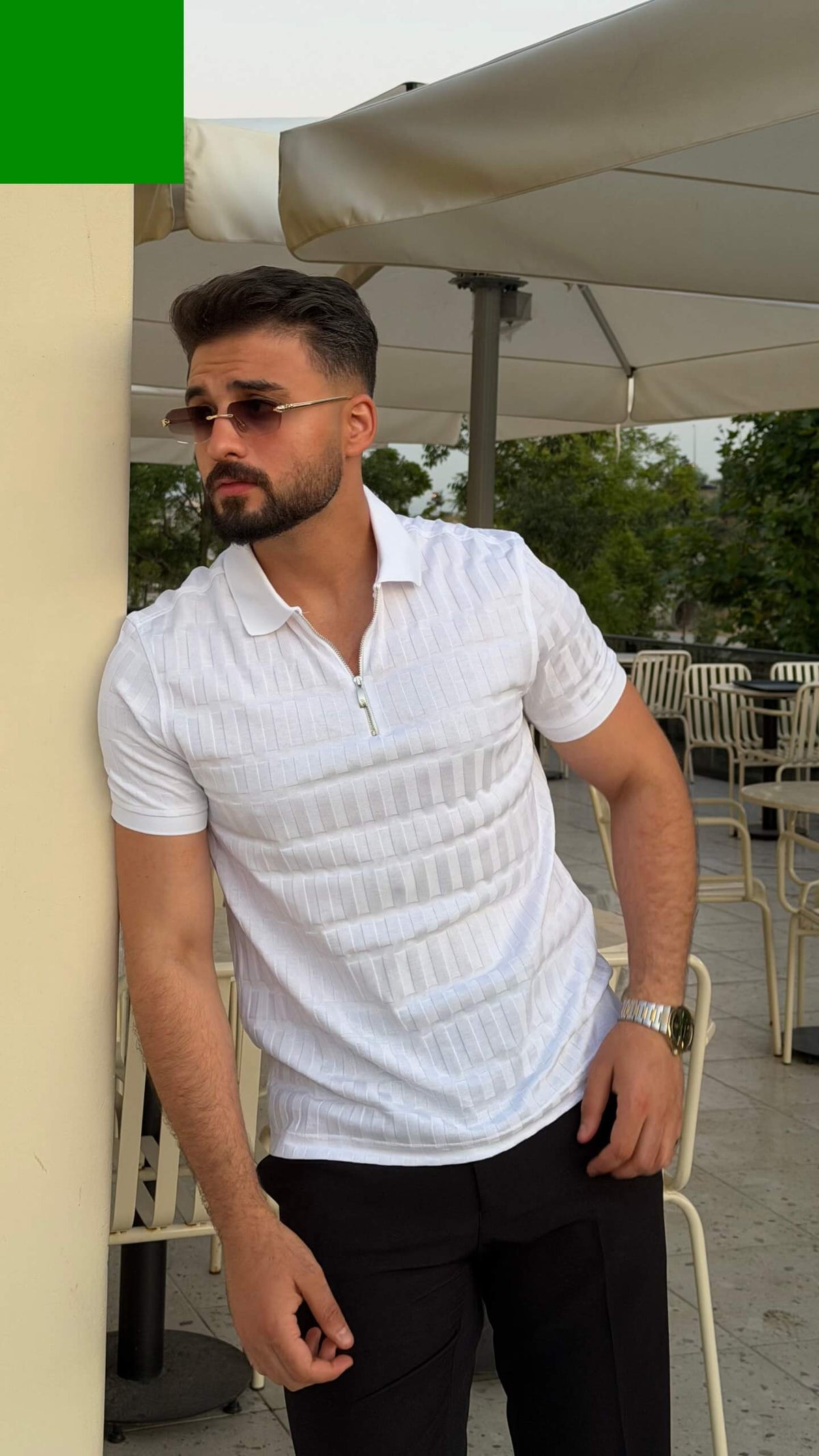 Men’s white knitted polo shirt with textured vertical detailing and smart casual style