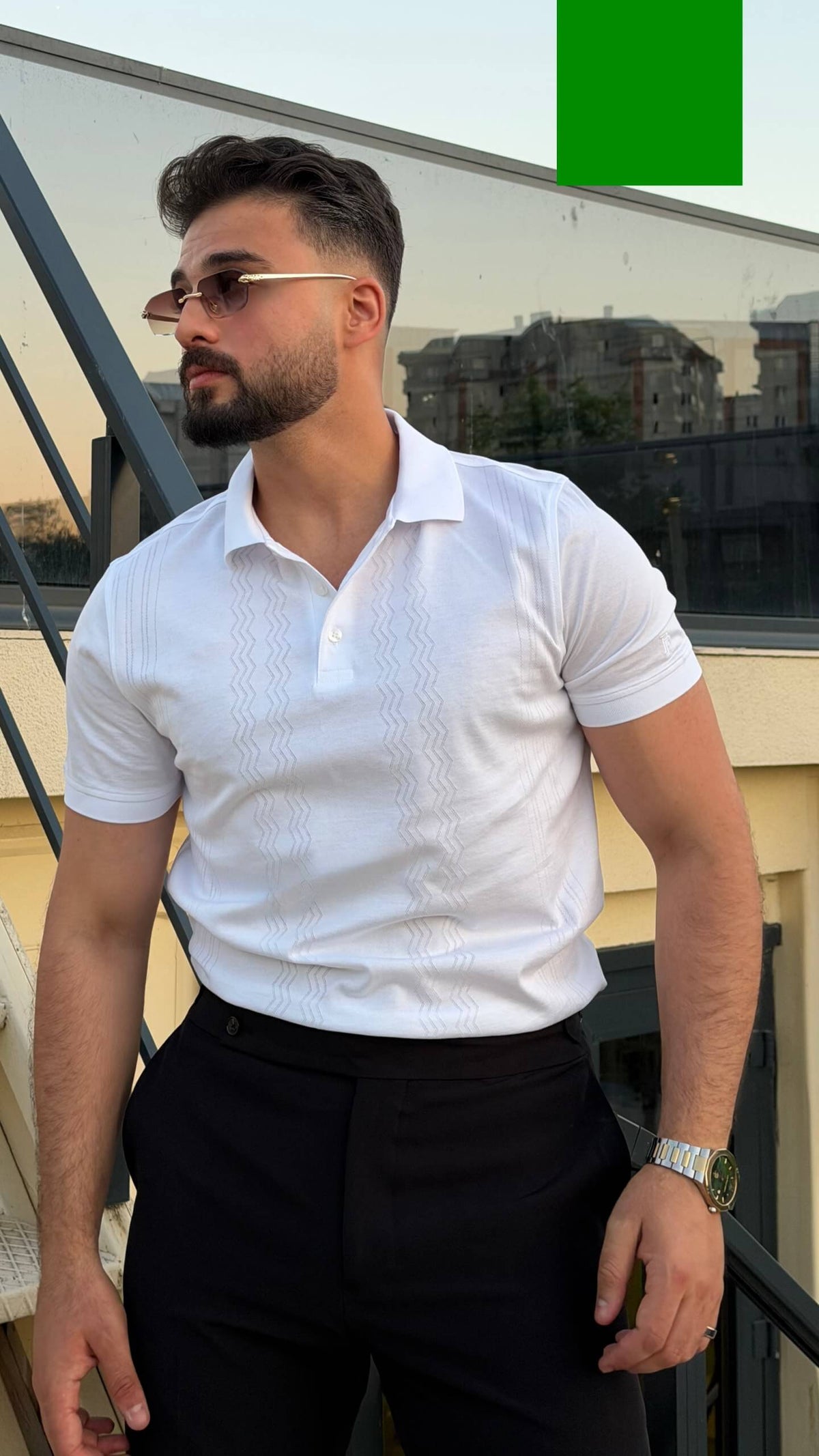 Men’s white knitted polo shirt with textured vertical detailing and smart casual style