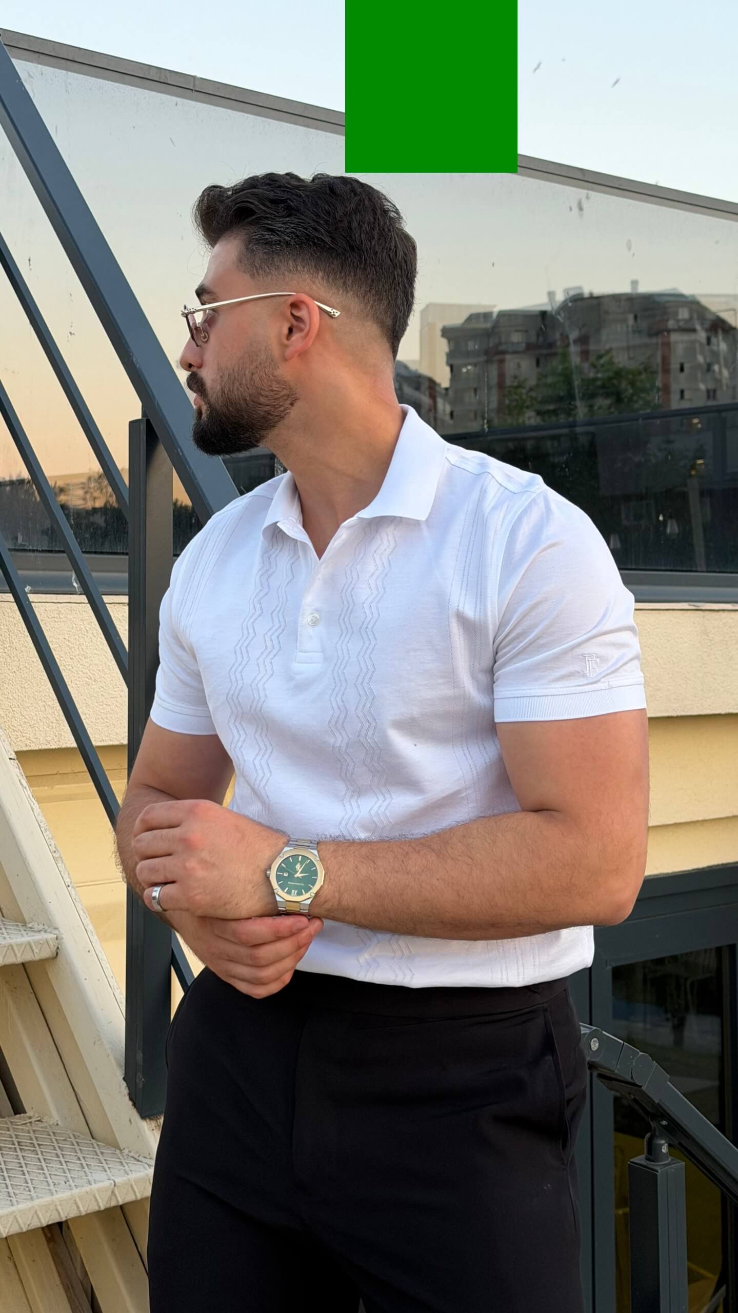 Men’s white knitted polo shirt with textured vertical detailing and smart casual style