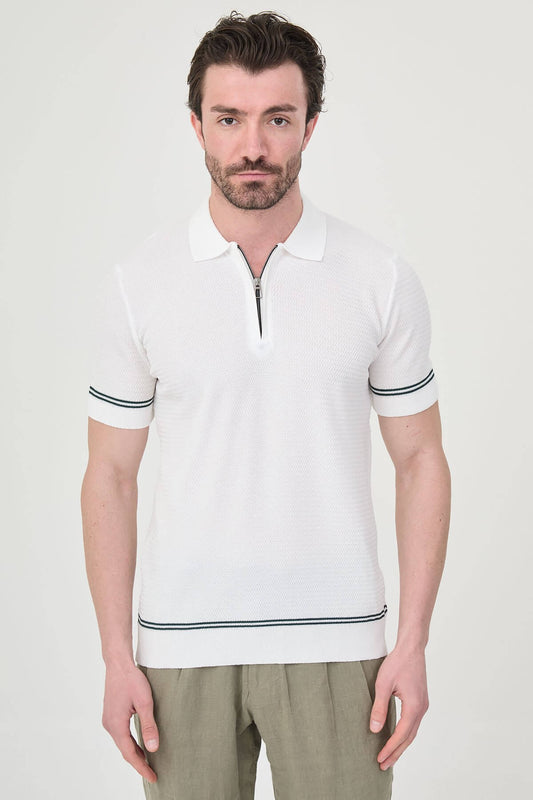 Man wearing white slim-fit quarter-zip polo t-shirt with dark stripe accents, styled with light brown trousers.