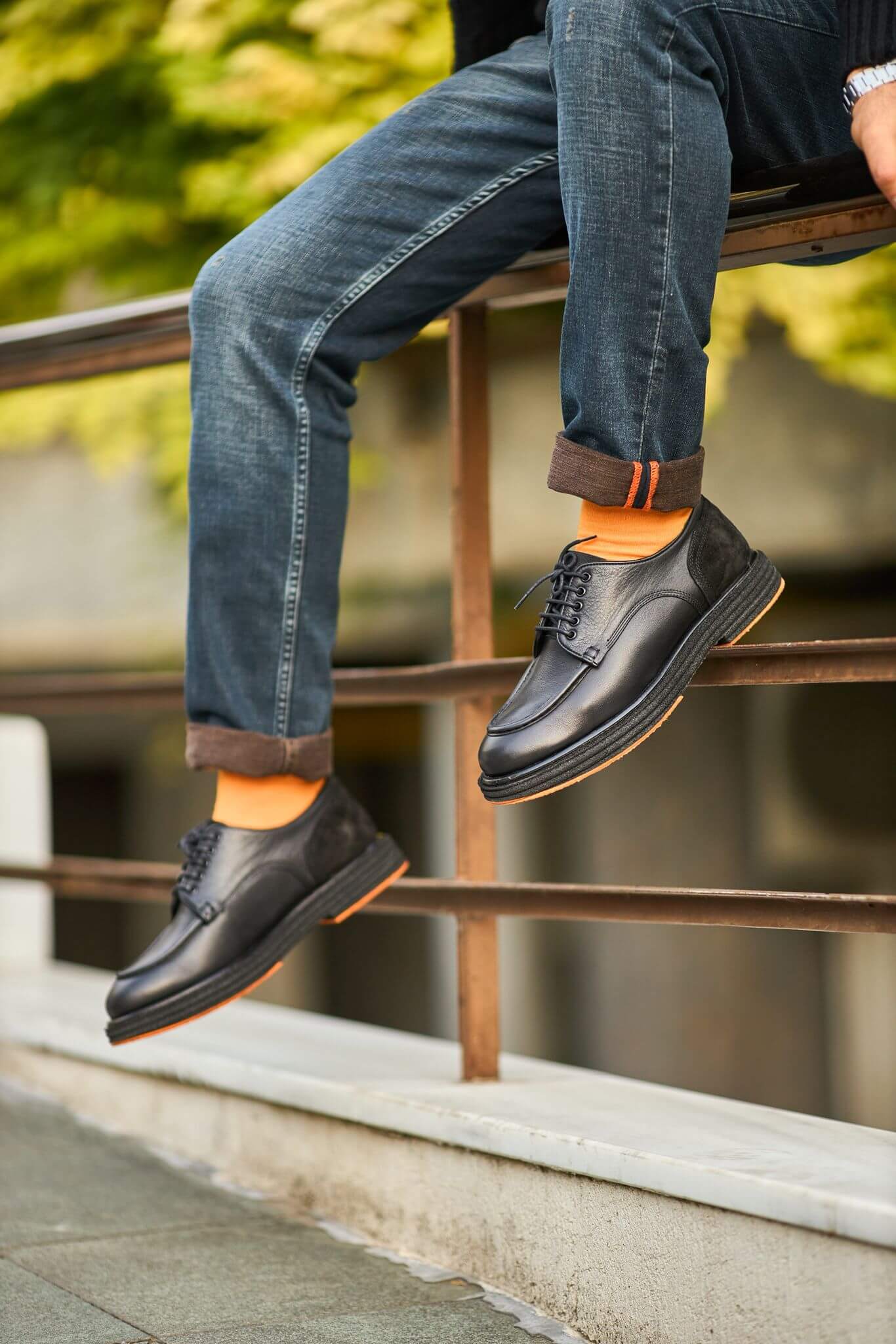 Men’s black leather derby shoes with moc-toe stitching and suede heel detail