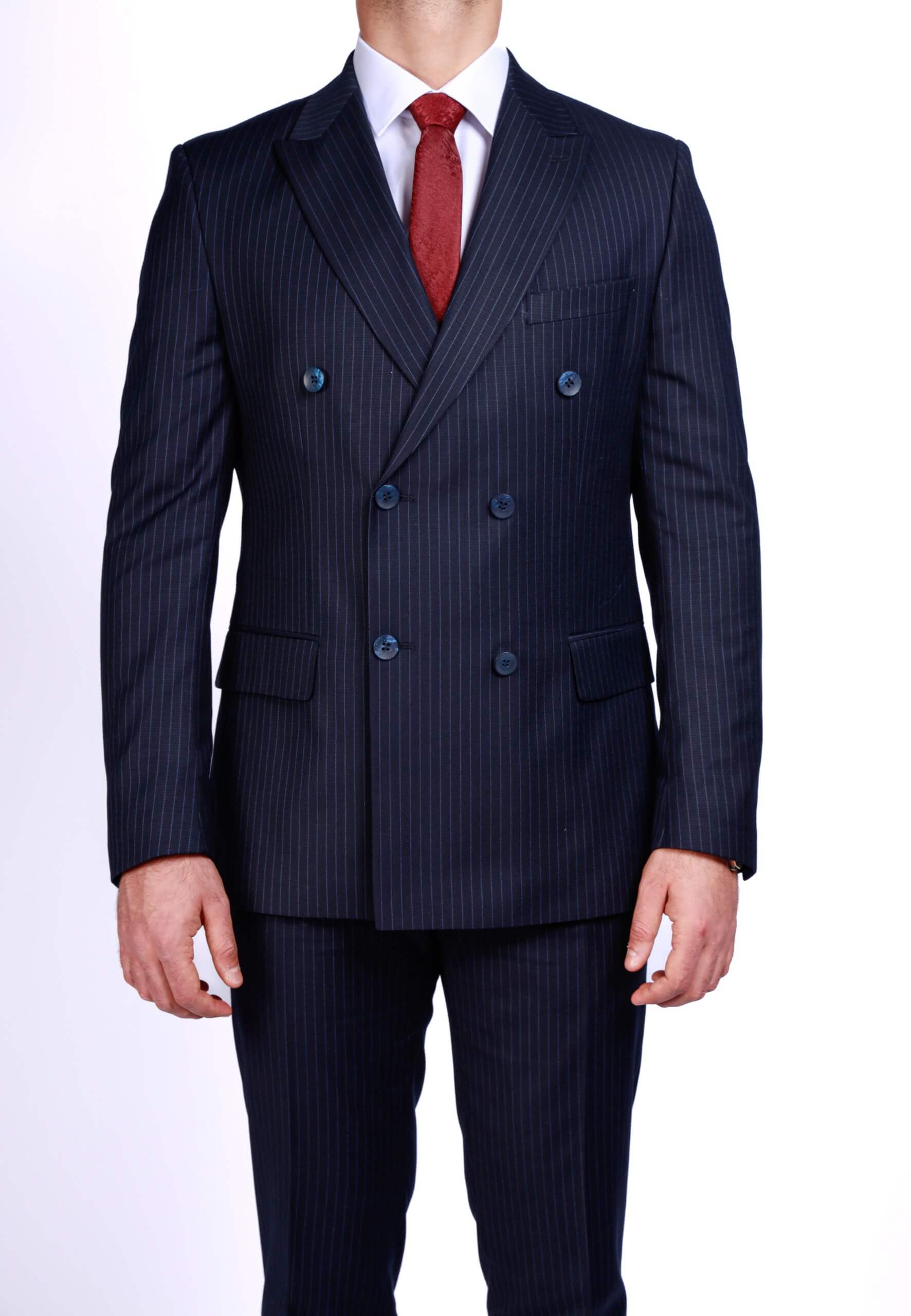 Men’s dark blue double-breasted pinstripe suit with peak lapels and slim-fit tailoring, worn with white shirt and red tie.