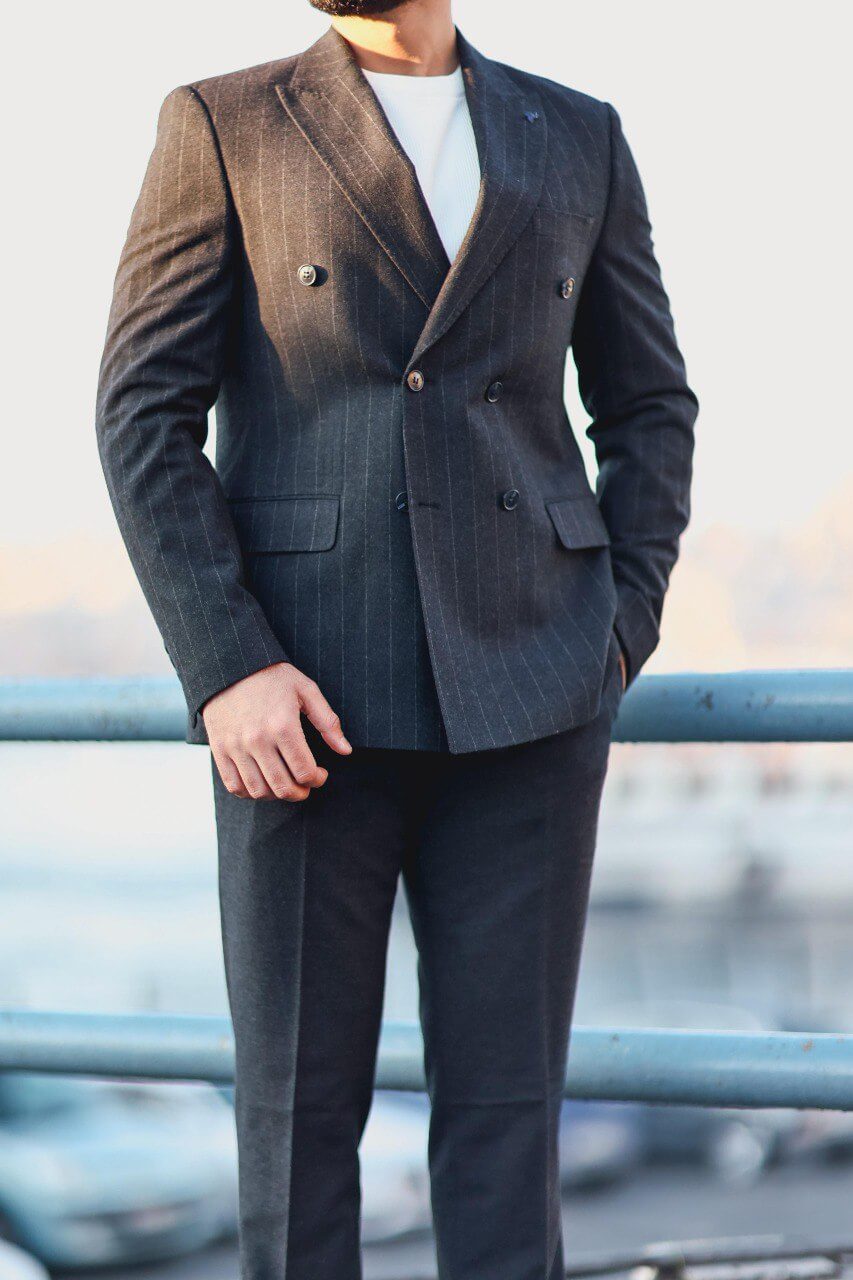 Men’s navy blue double-breasted pinstripe slim-fit suit styled with white knit top