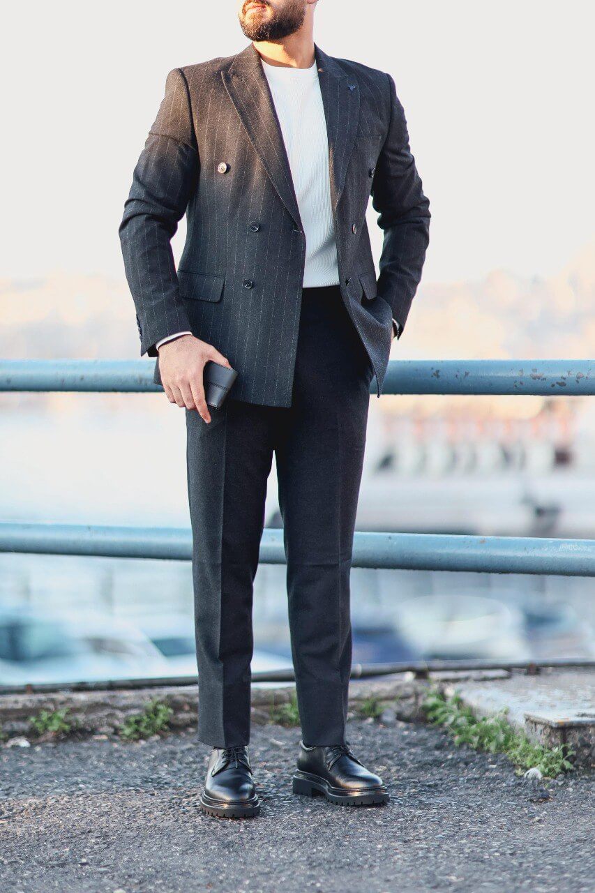 Men’s navy blue double-breasted pinstripe slim-fit suit styled with white knit top