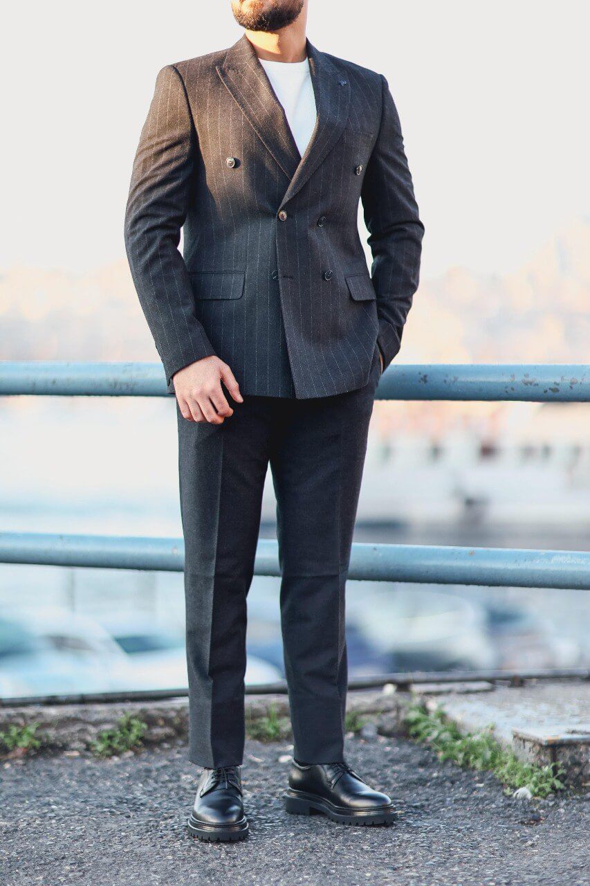 Men’s navy blue double-breasted pinstripe slim-fit suit styled with white knit top