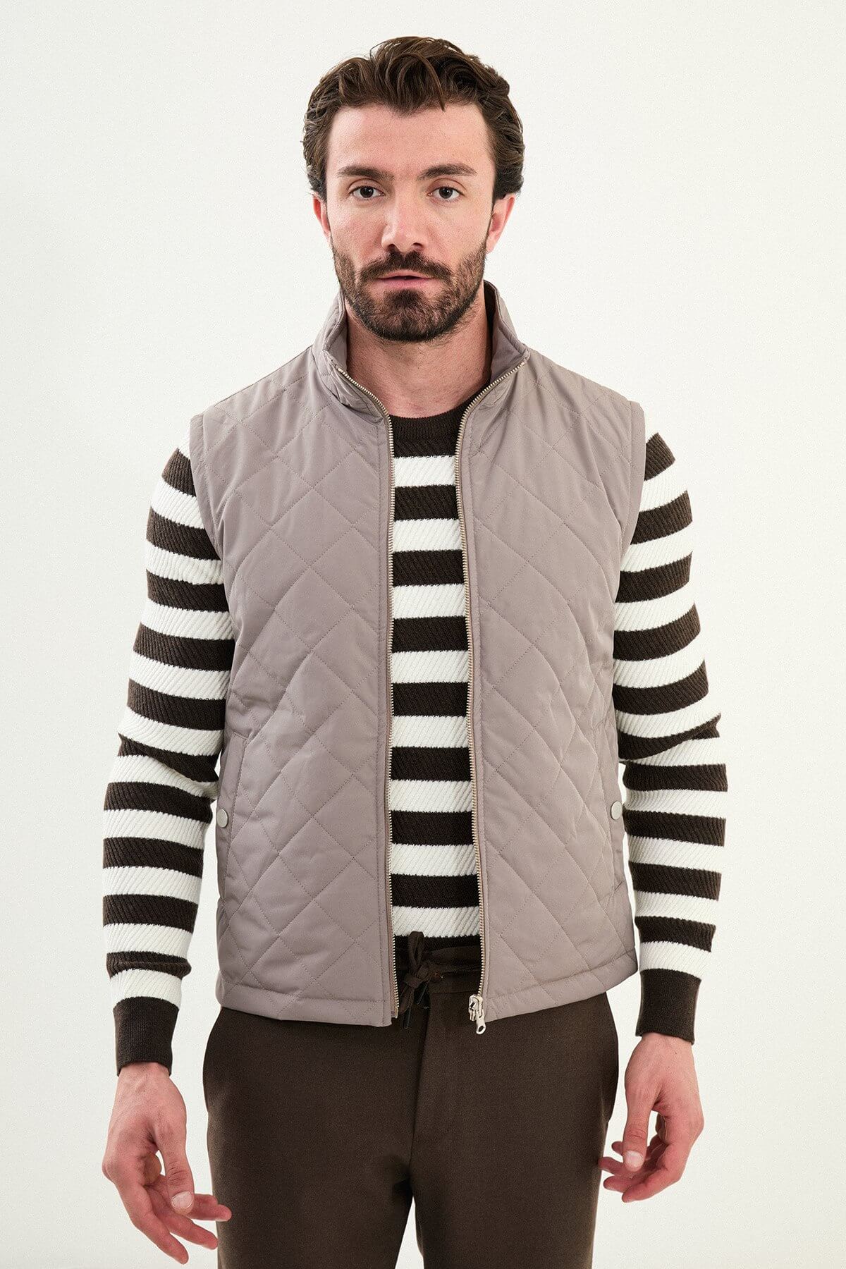 Men’s light brown matte technical utility vest with oversized pockets for winter layering.