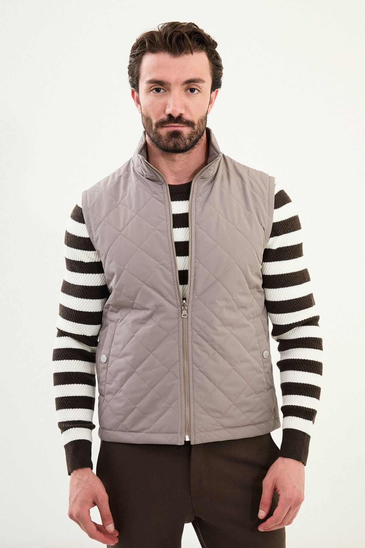 Men’s light brown matte technical utility vest with oversized pockets for winter layering.