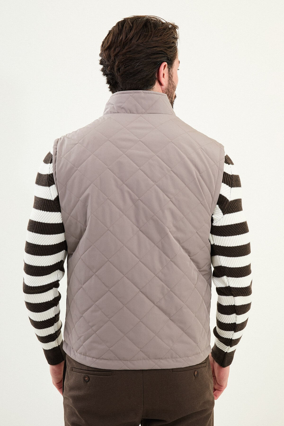 Men’s light brown matte technical utility vest with oversized pockets for winter layering.