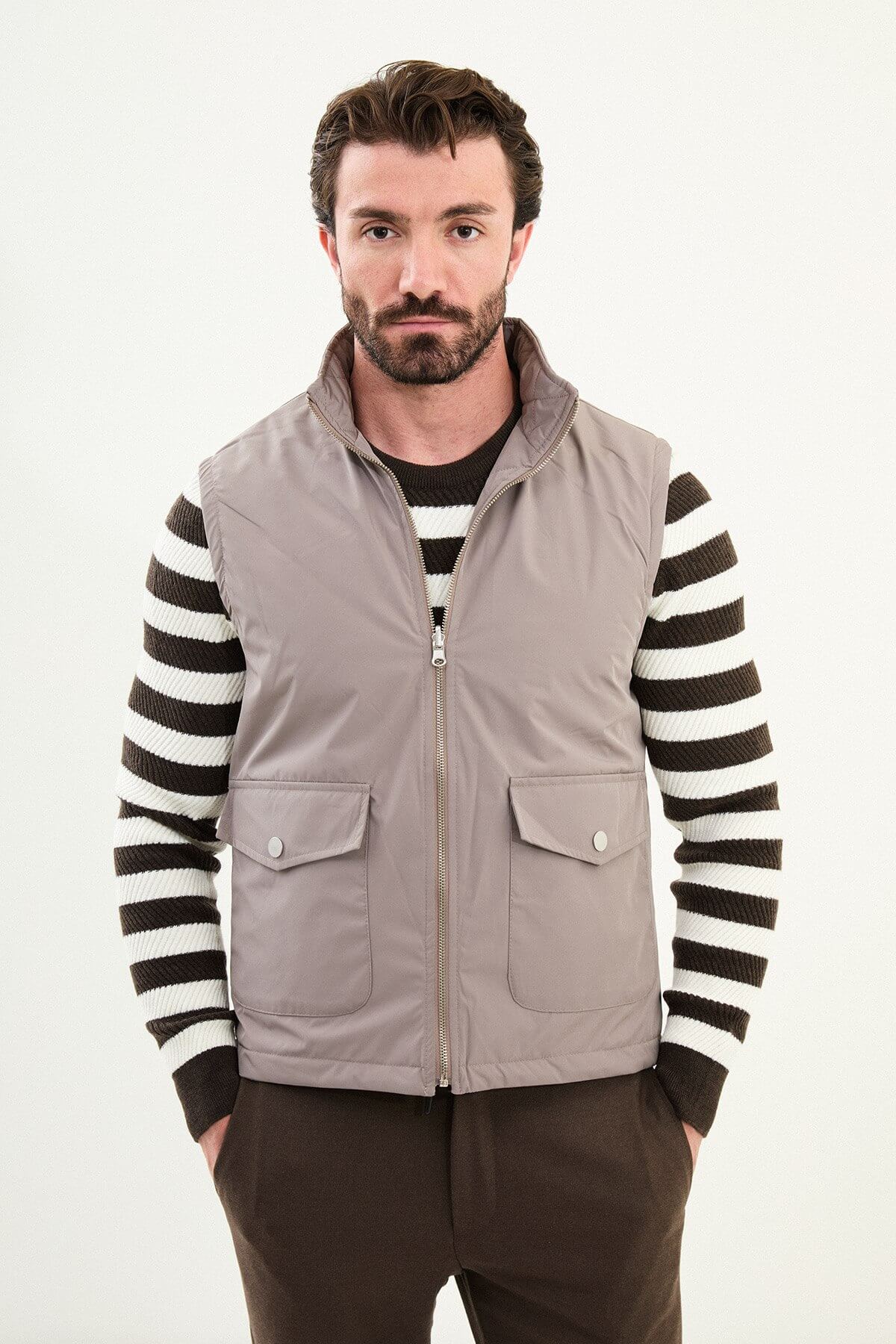 Men’s light brown matte technical utility vest with oversized pockets for winter layering.