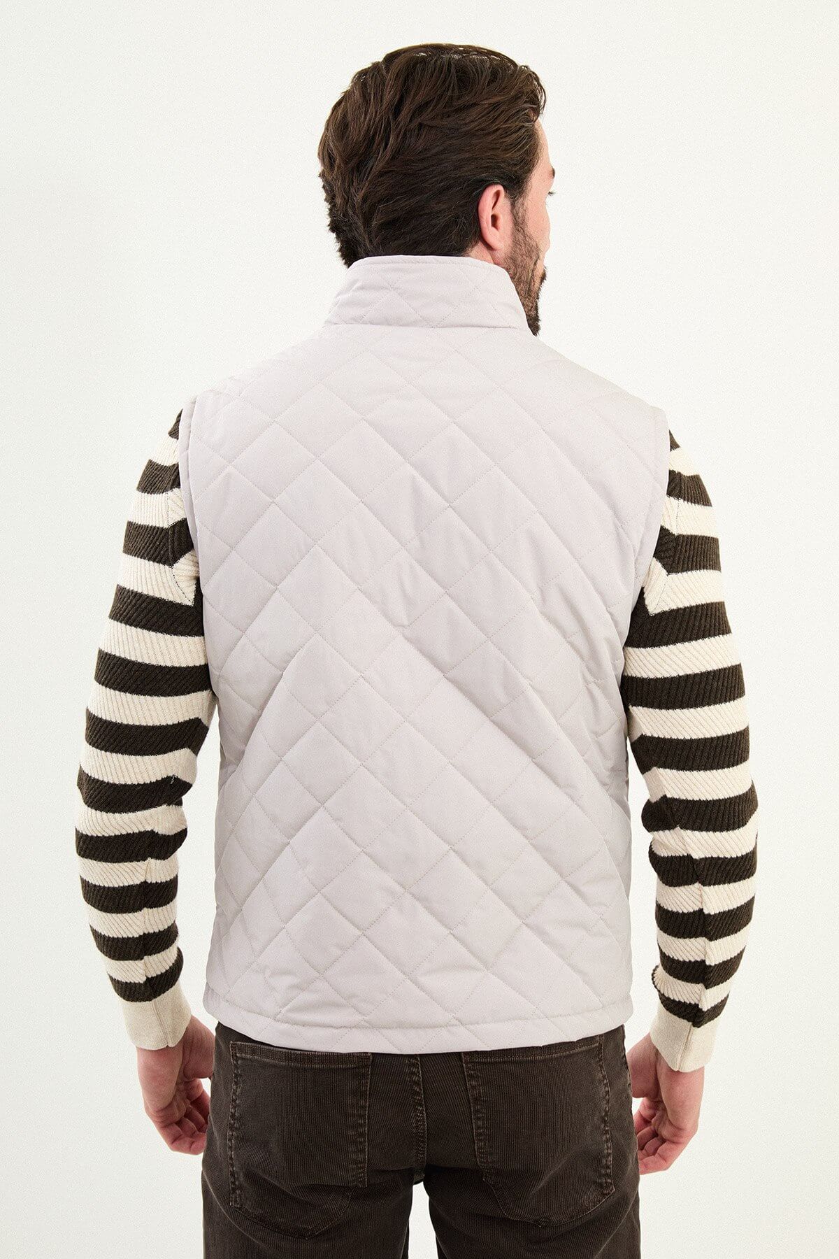 Light gray matte men’s technical utility vest with a stand collar, zip front, and two oversized snap-flap cargo pockets.