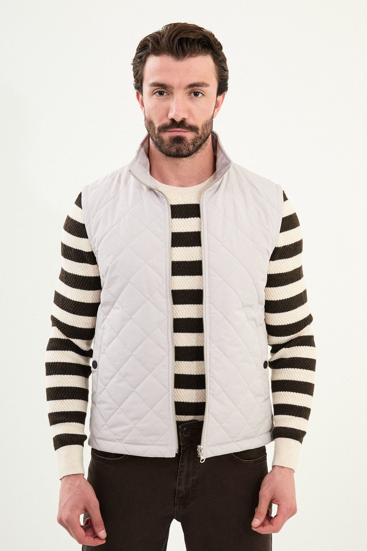 Light gray matte men’s technical utility vest with a stand collar, zip front, and two oversized snap-flap cargo pockets.