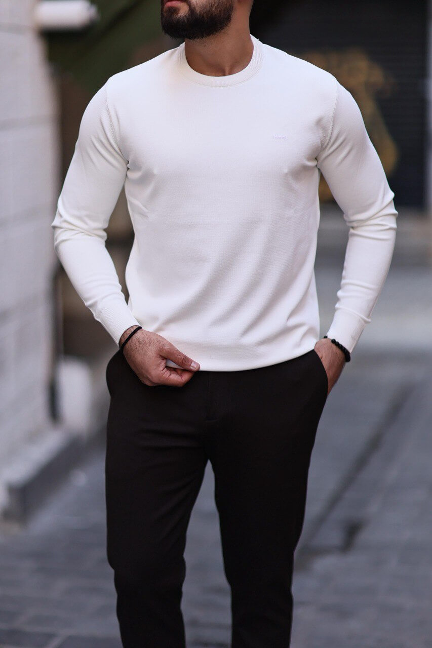 Men’s white slim-fit crew neck knitwear paired with black trousers