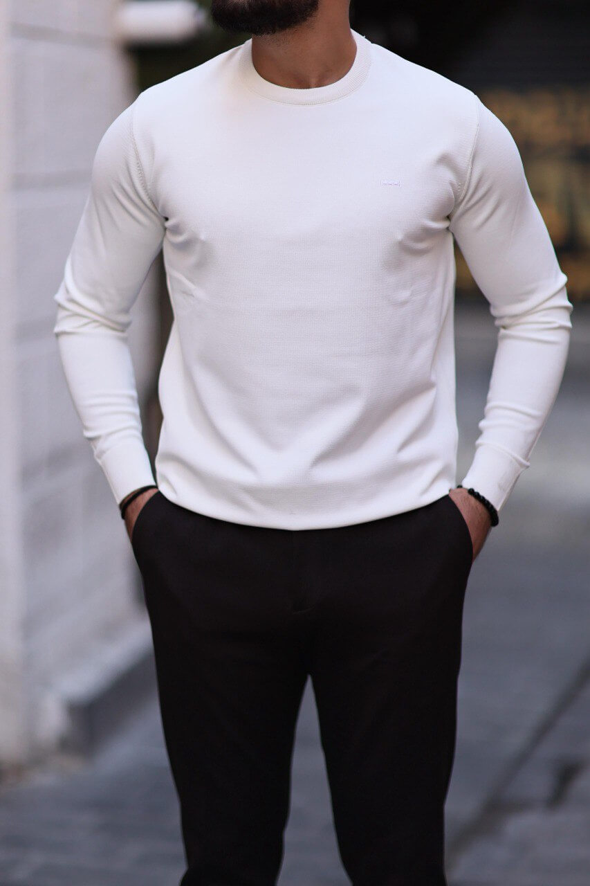 Men’s white slim-fit crew neck knitwear paired with black trousers