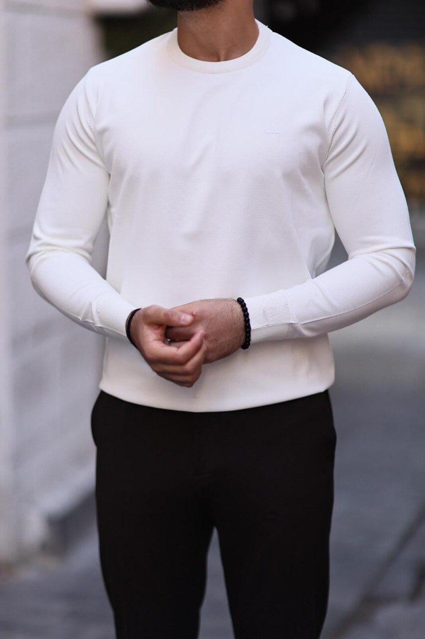 Men’s white slim-fit crew neck knitwear paired with black trousers