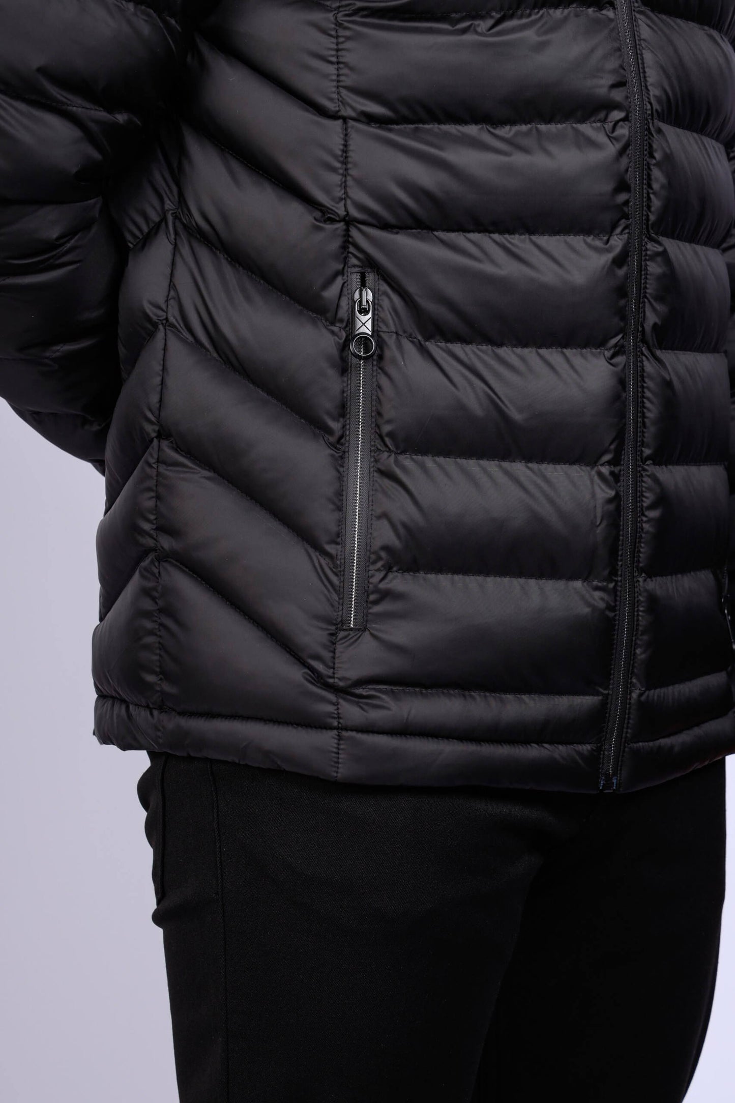Men wearing a black quilted puffer jacket with zip closure and stand collar, lightweight insulated fall winter outerwear.