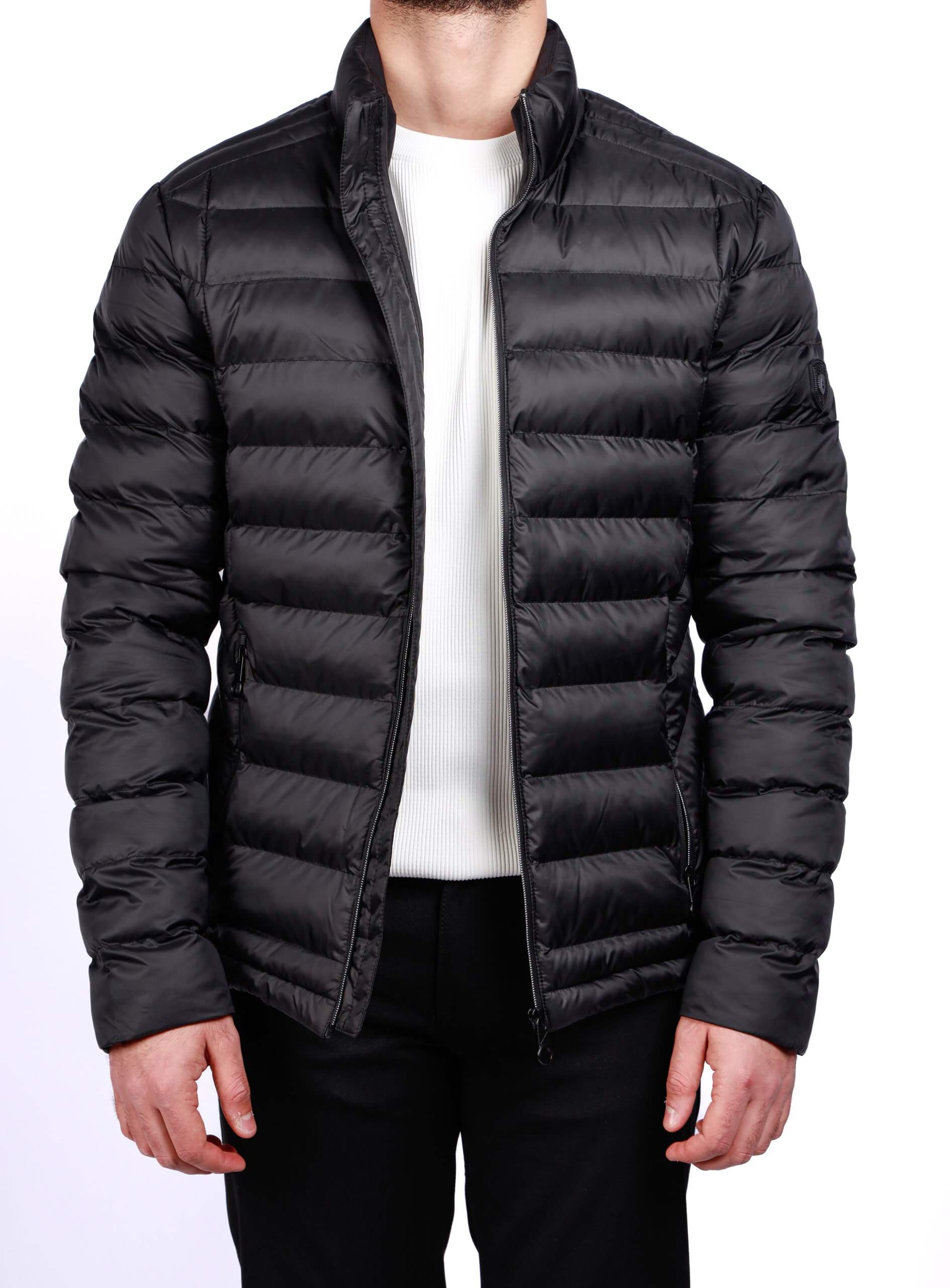 Men wearing a black quilted puffer jacket with zip closure and stand collar, lightweight insulated fall winter outerwear.