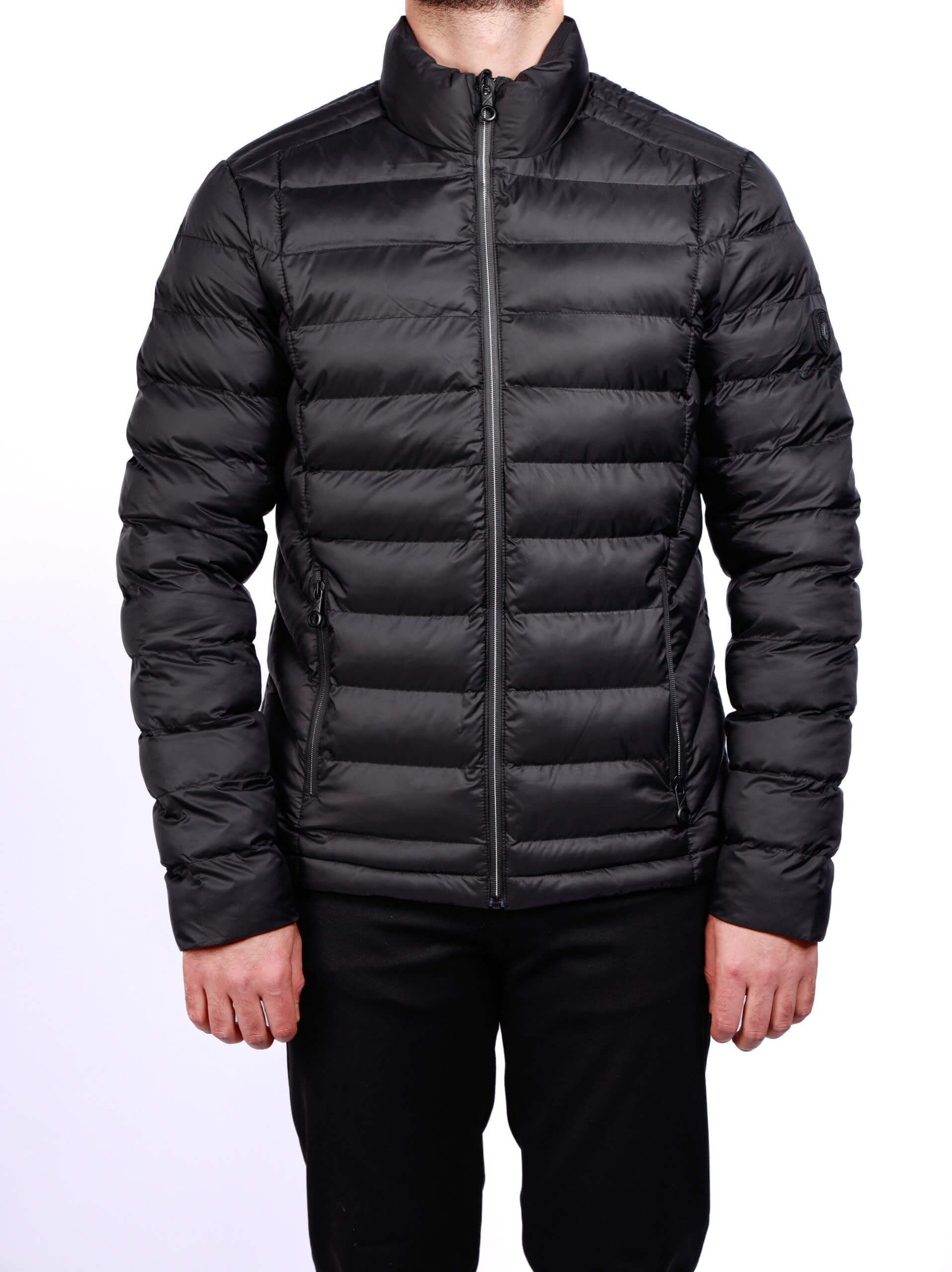 Men wearing a black quilted puffer jacket with zip closure and stand collar, lightweight insulated fall winter outerwear.
