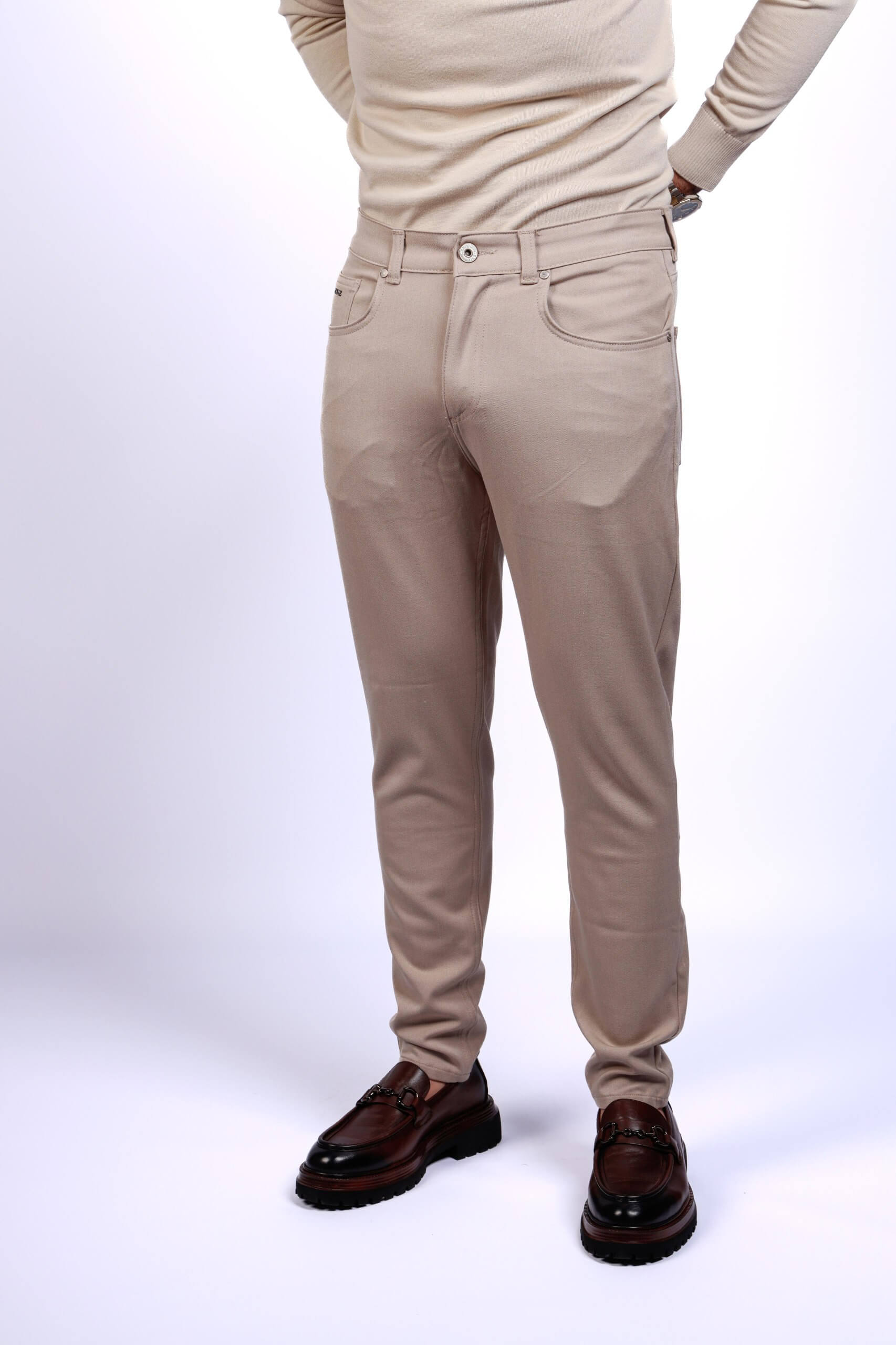 Men wearing beige slim fit stretch trousers with brown leather loafers