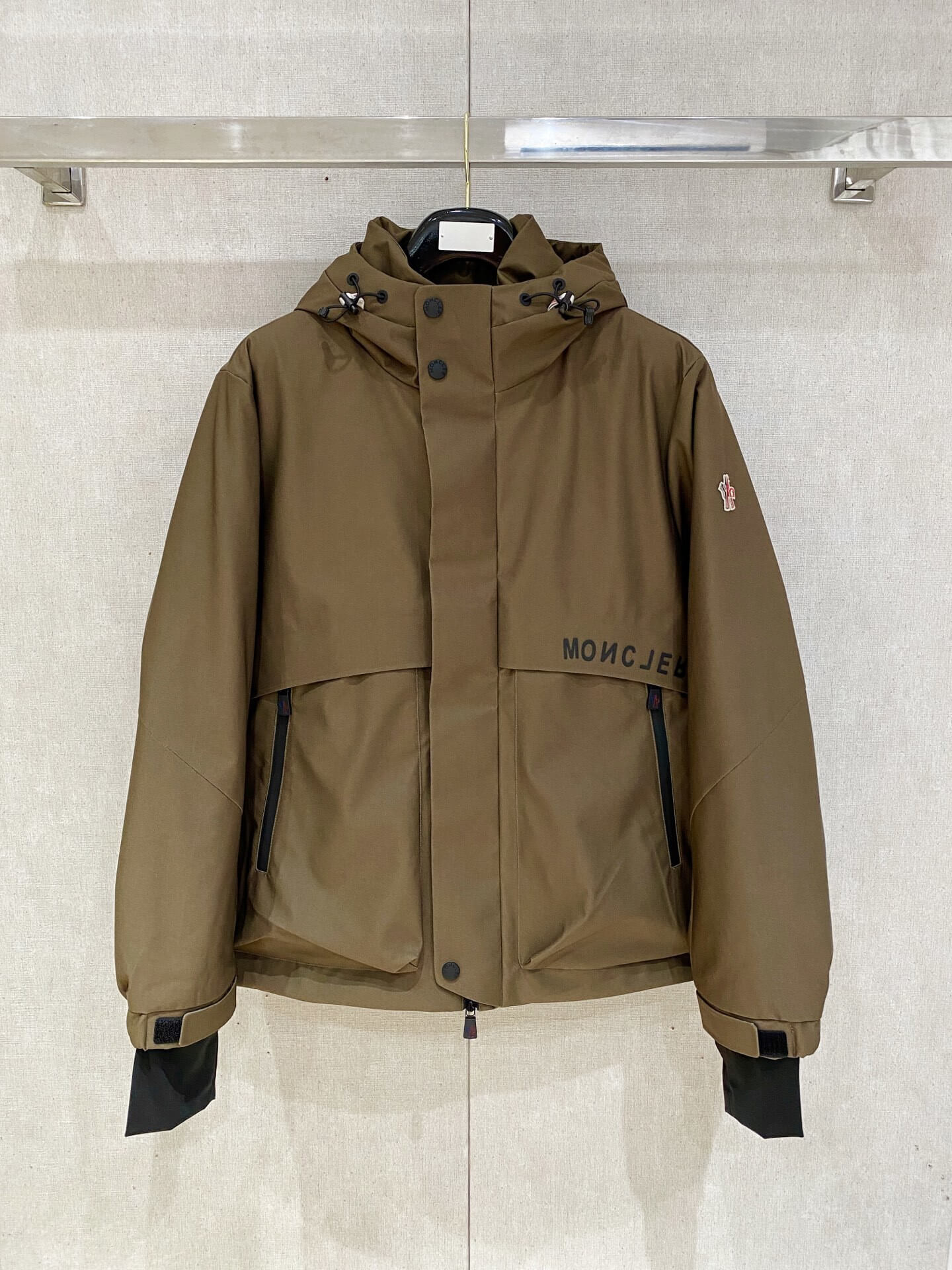 Brown ski down jacket with black insulated lining and hood, Moncler Grenoble-inspired design.