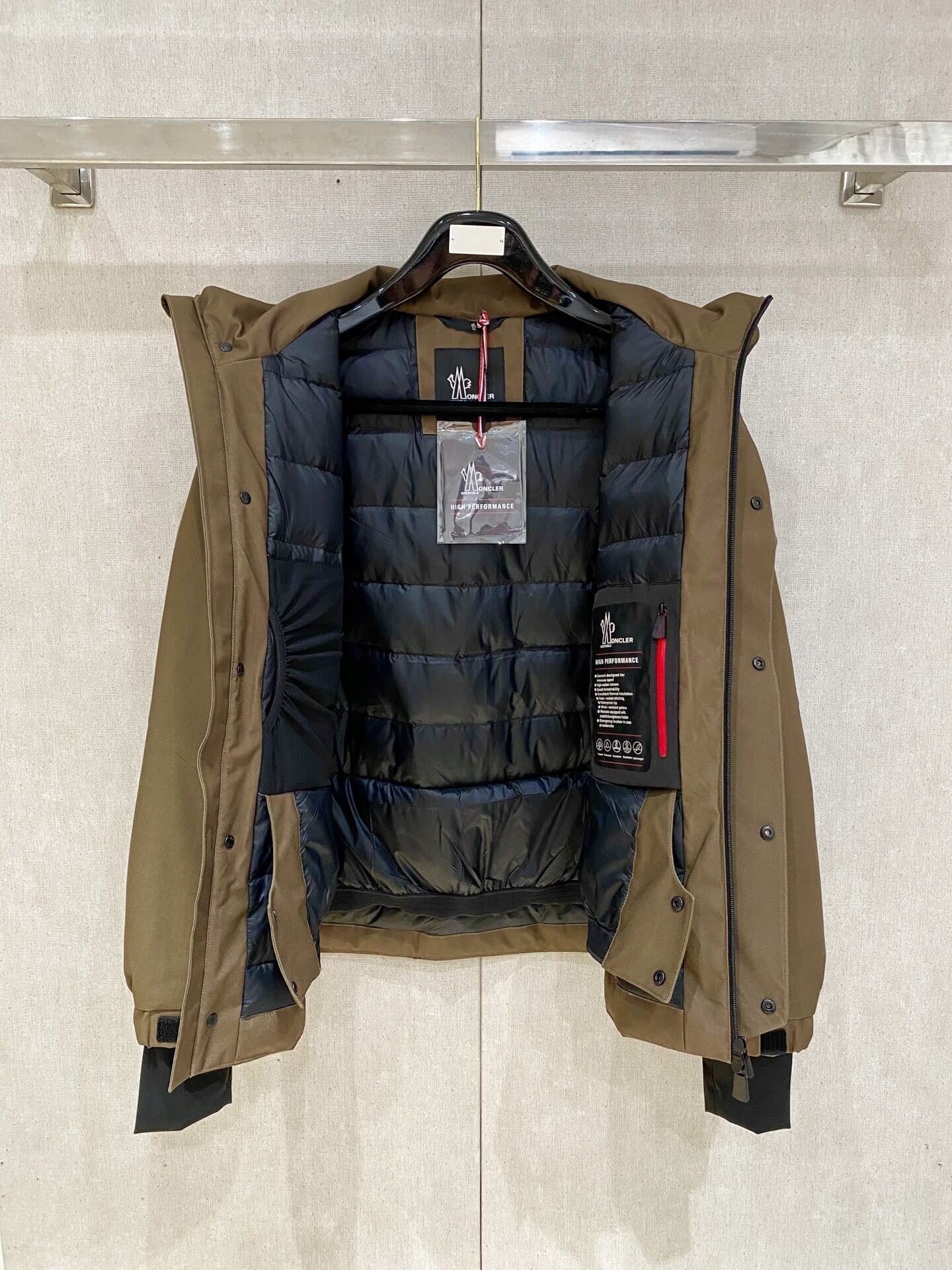 Brown ski down jacket with black insulated lining and hood, Moncler Grenoble-inspired design.