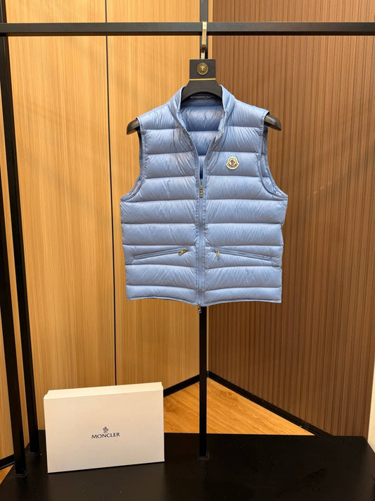 Light blue glossy down vest with chest logo patch and quilted panels, Moncler Gui-inspired.